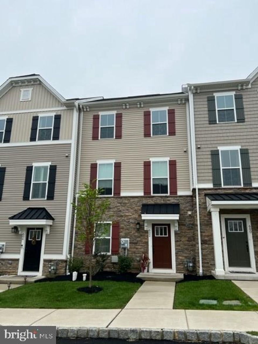 Welcome home to this beautifully appointed 3-bedroom, 2 full and 2 half bath townhome in the highly sought-after Atwater community, located in the award-winning Great Valley School District. Perfectly positioned for exceptional accessibility, this home is just minutes from the PA Turnpike, Routes 202, 29, 30, and 401, with easy access to I-76, and conveniently located near both the Malvern and Paoli train stations—offering seamless commuting to Philadelphia, King of Prussia, Exton, and beyond. Inside, a thoughtfully designed floor plan blends style and function, featuring a versatile entry-level flex space, powder room, and access to a spacious 2-car garage. The main living level showcases rich espresso flooring, an open-concept layout, and a beautifully upgraded kitchen with granite countertops, crisp white cabinetry, subway tile backsplash, and an oversized breakfast bar that flows effortlessly into the dining area and out to a private rear deck—perfect for entertaining. A bright and inviting living room along with an additional half bath completes this level. Upstairs, the luxurious primary suite features a tray ceiling, walk-in closet, and a spa-inspired ensuite bath with dual vanities, soaking tub, and separate shower, while two additional bedrooms, a full hall bath, and a convenient laundry area complete the upper level—an exceptional opportunity to own a stylish, move-in ready home in one of the area’s most desirable communities.