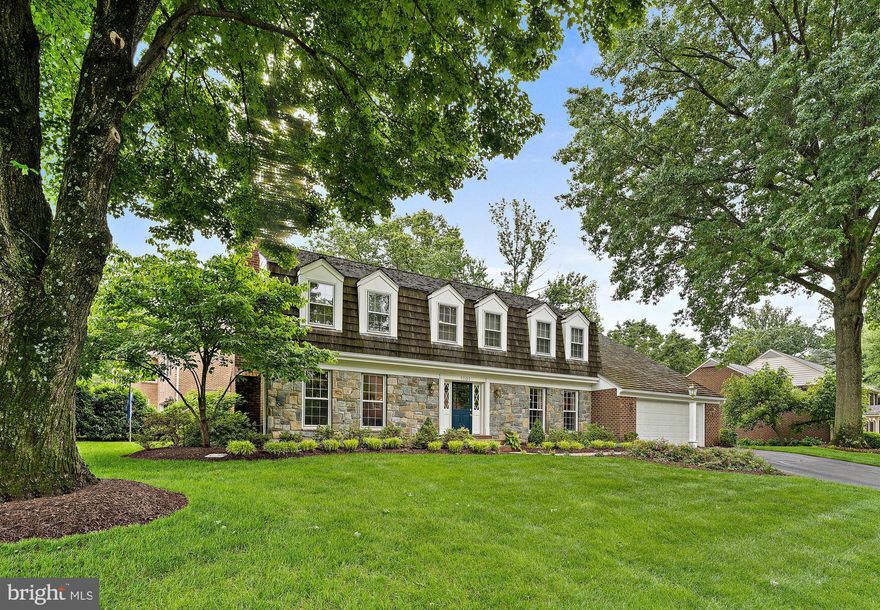 This is the one you’ve been waiting for!  Located in the desirable Timberly South neighborhood just minutes from vibrant Tysons and downtown McLean, this beautifully updated Dutch colonial home offers refined interior appointments, an abundance of space, exceptional indoor-outdoor flow, and placement in the top-tier Langley High School pyramid.  With 5 Bedrooms, 4 Full Bathrooms and 1 Half Bath, this home effortlessly adapts to every stage of life, offering room to live, work, and entertain.
Enter through a charming Dutch door into a 2-story foyer adorned with English-inspired details—Guy Goodfellow designer wallpaper, authentic brass light fixtures, wainscoting, and gleaming hardwood floors.  The formal Living Room features an elegant wood-burning fireplace and higher ceilings, while the Dining Room is dressed in Farrow & Ball lacquered walls, custom window treatments, and French doors that open to the kitchen.  A private Office offers peaceful backyard views, while the gourmet Kitchen impresses with Carrera marble countertops and backsplash, inset ceiling-height cabinetry, and premium KitchenAid stainless steel appliances. The adjacent Breakfast Area with a large bay window  is a delightful spot for morning coffee or a casual family dinner.  The generously sized Family Room offers a wood-burning fireplace, a fabulous wet bar with honed granite counters, built-in cabinetry, and an ice maker, as well as two sets of French doors leading to the flagstone patio.  A well designed and organized Laundry Room with separate side entrance and access to the 2-car Garage as well as a Powder Room with bespoke accents complete the main level.
Upstairs features 5 Bedrooms and 3 Full Bathrooms as well as hardwood floors throughout. The tranquil Primary Suite offers a wood-burning Fireplace with marble surround, dual closets, and a serene en-suite Bath with 2 separate sink vanities, a standalone shower, and soaking tub.  Three additional Bedrooms, one with en suite Bath, include ample closet space and designer accents.  An updated full Hall Bathroom and additional wide linen closet are perfect for an expanding lifestyle and staying organized.
The lower level includes an open and spacious Rec Room with a home theater set up, fully equipped with projector, screen, and surround sound.  A dedicated fitness area with mirrored walls and soft touch dance flooring makes the perfect spot for in-home fitness, yoga, or pilates.  The oversized Guest Room and Full Bathroom are ideal for extended stays or au pair accommodations.  There are several storage options in the lower level as well.
One of the home’s most captivating features is its outdoor living space. The beautifully landscaped backyard is highlighted by a flagstone patio with a built-in circular seating area, an enchanting pergola draped in climbing wisteria, and lush mature plantings. Whether hosting summer gatherings or enjoying quiet alfresco dinners, the outdoor environs offer the perfect setting for relaxation and entertaining.
Ideally located just minutes to Tysons with world class shopping, dining, and entertainment venues as well as the Silver Line metro.  Equidistant to Dulles International and Reagan National airports.  Minutes to downtown McLean with local shops and restaurants.  Easy access to I-495, the GW Parkway, and the Dulles Toll Road.  A must see in one of McLean’s top neighborhoods.