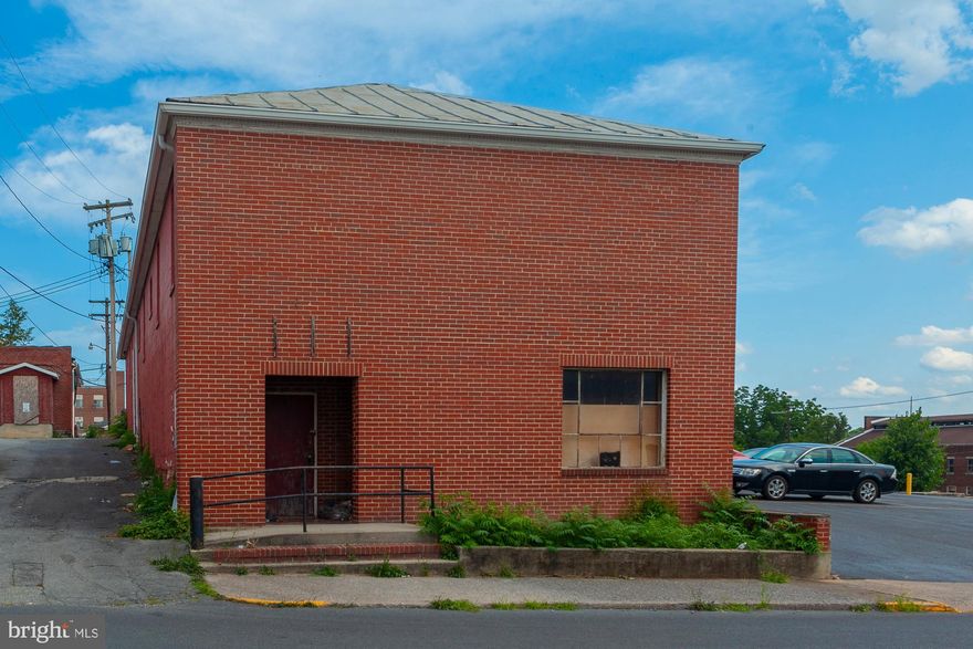 218 South College St.  Martinsburg, WV. A 6000 Sq. Ft building with two large parking lots for approximately 20 cars in down town Martinsbug. Versatile property with great potential for office building.   offers the flexibility to design the space according to your specific requirements. The downtown location adds value, providing easy access to amenities and potential business opportunities. With approximately 6000 square feet, it could be suitable for various uses, especially as  office space  or warehouse space. Build it out to suit your needs. The two parking lots, part of the property,  front King Street and are accessed from 218 South College.  Buyer to do  own Due Diligence. Exceptional opportunity.