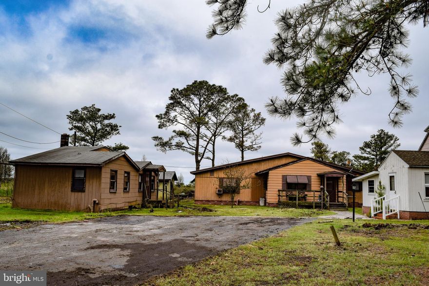 3 homes for less than the price of 1! This community of three houses sits down a paved blacktop driveway with three sheds included. The homes share a well but each has their own public sewer hookup (without the cost of city taxes). The pink two-story house has been gutted downstairs, updated windows throughout, and the upstairs has knotty pine hardwood floors and views of Daughtery Creek. House #1 is 1 bedroom 1 bath. House #2 is 1 bedroom 1 bath. House #3 has the potential to be 3+ bedrooms and 2 bath. This property is perfect for a large family who wants to be in close proximity but still have their own space. You are within walking distance to Jenkins public boat ramp and Daughtery Creek; one of the Eastern Shore's beauties (sunrises, sunsets, fishing, crabing, kayaking, boating, etc.) Property is being sold as-is.