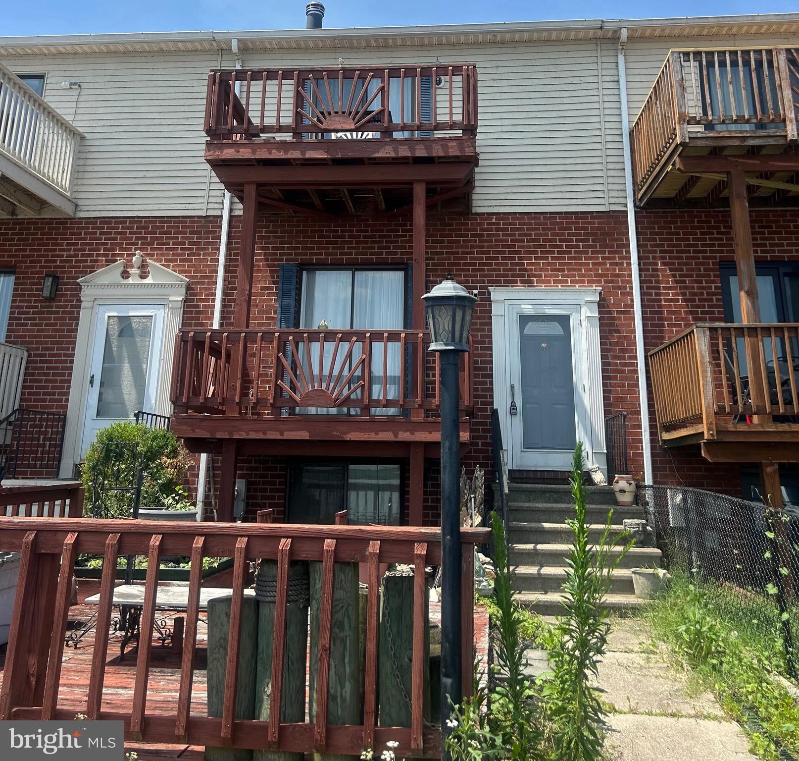 Unlock the potential of this 3-story, 3 bedroom, 2-bath waterfront townhome, a unit with gorgeous views of blue skies and shimmering water! Boasting two balconies and a lower-level patio with breathtaking water views, it is the perfect retreat for relaxation. Outside, take advantage of the private community pier with multiple dock slips, available on a first-come, first-serve basis - perfect for boaters, fishers, and water sports enthusiasts. Enjoying activities like paddleboarding and crabbing to soaking in stunning sunsets and front-row views of the 4th of July fireworks, this home is an incredible opportunity to create your dream waterfront getaway with a little elbow grease.
