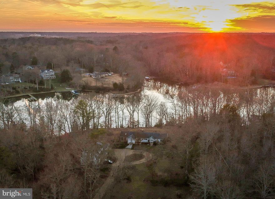 Waterfront property on popular Mill Creek.  Rambler with hardwood floors,  Great room has arched ceiling, tiled floor, fireplace, french doors to 25 x 15 screened porch overlooking the creek.  Kitchen has an island with commercial range & hood, dining area is open to kitchen and features a second fireplace with wood stove insert.  Basement has second bath, workshop area, craft area .  Detached garage / shop with wood stove &  full set of steps to second story.  Beautiful panoramic views.  Private lot.  Close proximity to Solomon's Island  by car or boat!