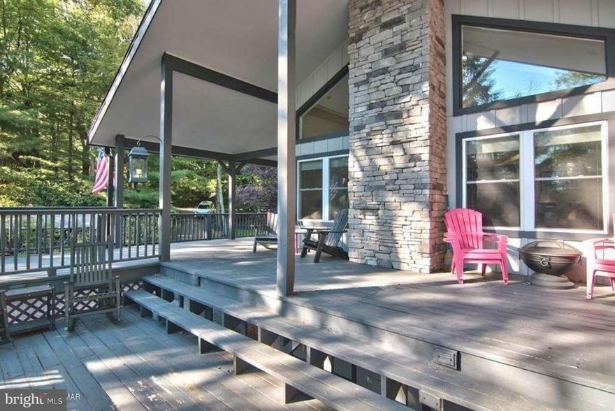 SERENITY NOW can be yours   !!   Enjoy the lakefront view!  Luxury has never been more desirable  so  why not make this your happy hideaway?     Tucked away on a pristine 3/4 Acre  wooded lot overlooking breathtaking Lake Harmony  119 N Lake Drive is one of the lakes only almost totally  private and hidden homes .... yet  is still close enough to enjoy all the Lake has to offer.    Wrapped in  decks and with views for days you could easily have 4 separate fires going at once  while you enjoy the natural beauty of  the land.       But that's not all ..  this waterfront  home features a modern kitchen that opens to a large family room with  gorgeous  wood burning stone fireplace for cozy winter nights  and spectacular views of the lake.   The main level has a primary bedroom complete with en suite and spacious powder room and a 4th bedroom/ den that opens to the multi level deck. The upper level has 2 large bedrooms and another full bath and  The lower level is full of possibilities and features a game room  and bar and can be used as additional guest space / in law suite or  bonus space/ secondary family room  The home has so many upgrades including new HVAC system, new grinder pump,   updated decking and many separate green space areas purposefully designed for fun and relaxation.  Enjoy four seasons of fun!  Short walking distance to all restaurants - and live outdoor music at Nick’s!  Close to some of Pa's best skiing  in winter and  Harmony Water sports in summer  AND just a  short walk to the Lake Harmony INN this home could  be your own personal slice of Heaven on Earth.