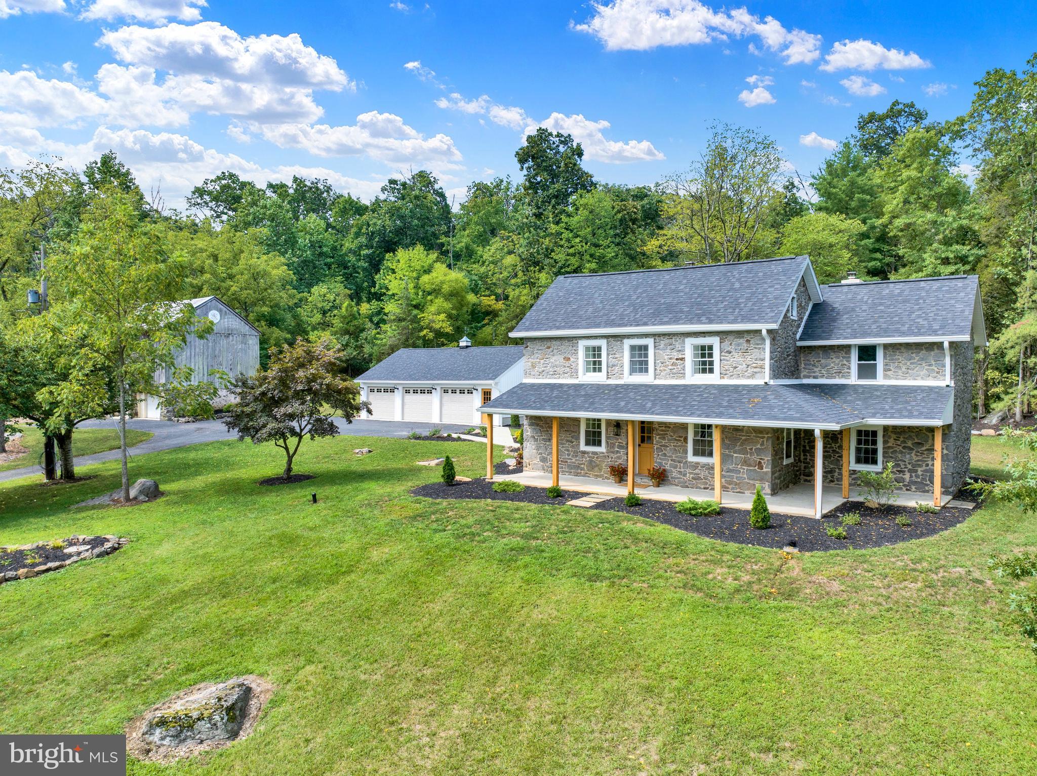 Stunning Farmhouse on Nearly 11 Acres in Upper Frederick Township!
This completely renovated 5-bedroom, 2.5-bathroom stone farmhouse offers over 2,700 square feet of living space and a perfect blend of timeless charm and modern comfort. Set on just under 11 acres, including more than 7+ wooded acres with scenic trails, the property also features a spacious detached 3-car garage and an attractive bank barn with an additional 2-bay garage. Renovated from top to bottom in 2024–2025, the home showcases exceptional craftsmanship inside and out. The tasteful landscaping frames the property beautifully, and the surrounding land invites you to explore its trails and enjoy the abundance of nature. Step inside the foyer to find a thoughtfully designed kitchen complete with stainless steel appliances, quartz countertops, and a custom range hood. The spacious dining room is perfect for hosting, while the sunken living room is anchored by a large stone fireplace and built-in cupboards. A newly updated powder room and four generous closets add convenience to the first floor. There is also a versatile bonus room that could serve as an office, hobby space, or small fifth bedroom. The formal sitting room, with exposed beams, provides access to the basement and features a refinished staircase leading to the second floor. Upstairs, charm and practicality come together. The hallway is accented by original farmhouse stone walls and exposed beams. The brand-new laundry room offers ample storage, workspace, a sink, and custom shelving, as well as access to the attic. One bedroom features a cathedral ceiling with a wooden beam and a decorative stone fireplace, while the centrally located hall bathroom includes a tiled shower and an exposed stone wall. The primary suite is a true retreat, offering a walk-in closet and private bath, both with sliding barn doors. The en suite bath showcases an original stone wall with a built-in cubby, a walk-in tiled shower, and a double-bowl vanity. Two other ample sized bedrooms round out the 2nd floor. Recent upgrades include a new roof, new gutters, a new heating and cooling system, new electrical and plumbing throughout, new drywall, trim, and paint, and new or refinished flooring. The property is home to an abundance of wildlife including deer, turkey, and an array of birds. Its location near Green Lane Park and Perkiomen Rail Trail provides endless opportunities for hiking, biking, boating, horseback riding, and more. The property is also enrolled in the Clean & Green program, reducing taxes by nearly $2,700 annually. Move-in ready and brimming with charm, this farmhouse offers a rare combination of historic character and modern luxury. Schedule your personal tour today!