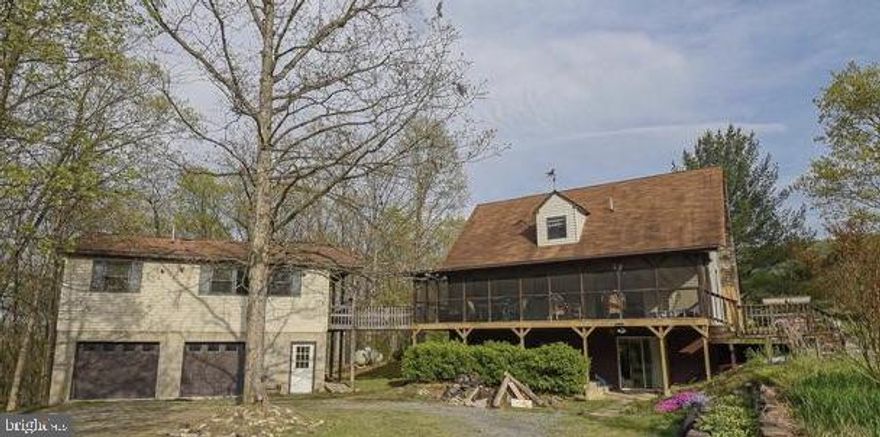 “LIVE HOW YOU WANT TO” – UNIQUE COUNTRY ESTATE ON 8 ACRES ONLY 6 MILES FROM U.S. ROUTE 50.  FEATURES 6 BEDROOMS, 3½ BATHS AND 3 KITCHENS.  MAIN FLOOR OFFERS NEW KITCHEN W ALL APPLIANCES,  BREAKFAST BAR/ISLAND & 2 PANTRIES. SEPARATE DINING ROOM, LIVING ROOM W CUSTOM CENTERPIECE FIELD STONE FIREPLACE.  LOWER LEVEL INCLUDES WALK OUT ENTRANCE, FAMILY ROOM W KITCHENETTE & GAS LOG FIREPLACE.  2-CAR DETACHED GARAGE W OVERHEAD 2 BEDROOM, 1 BATH “MOTHER-IN-LAW” SUITE OR APARTMENT.  OTHER AMENITIES: LARGE COVERED AND SCREENED-IN PORCHES, GRAVEL DRIVEWAY W HEAVY STONE INLAY, FULLY STOCKED POND, ¼ ACRE FENCED-IN PET AREA, VERY PRIVATE LOCATION, YET ONY MINUTES FROM SHOPPING, HOSPITAL. 
HOME With 5.54  ACRES FOR $369,500