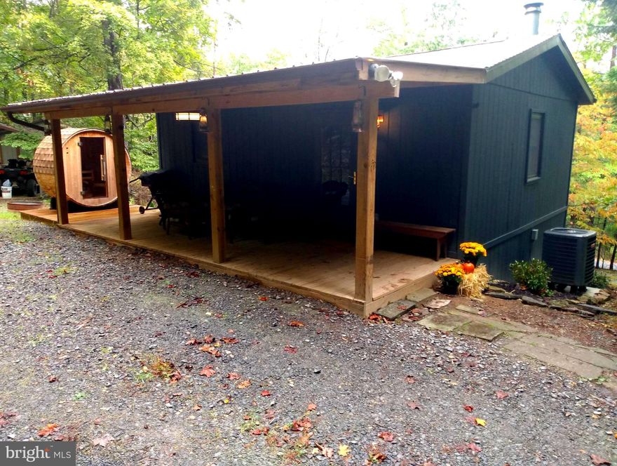 Cabin in The Woods! Completely renovated in 2021 with 100% new interior including windows, doors, hardwood flooring, wood ceilings, complete and modern kitchen & bath.  Washer/ Dryer combination. Central air and heat as well as a woodstove for the chilly winter days. Full front porch with new wooden Sauna.  Shed / Workshop, Carport. The community has private access to 9 acres on the most scenic area of the Cacapon River. Enjoy fishing, swimming, kayaking on the river and a warm campfire in the evenings.  This cabin sets very privately on 2.30 Acres just minutes from Berkeley Springs WV with all the shops, restaurants, spas and entertainment. Make your appointment Today!
Multiple Offers in Hand, All Offers to be in by Sunday 10/1 at 3pm.