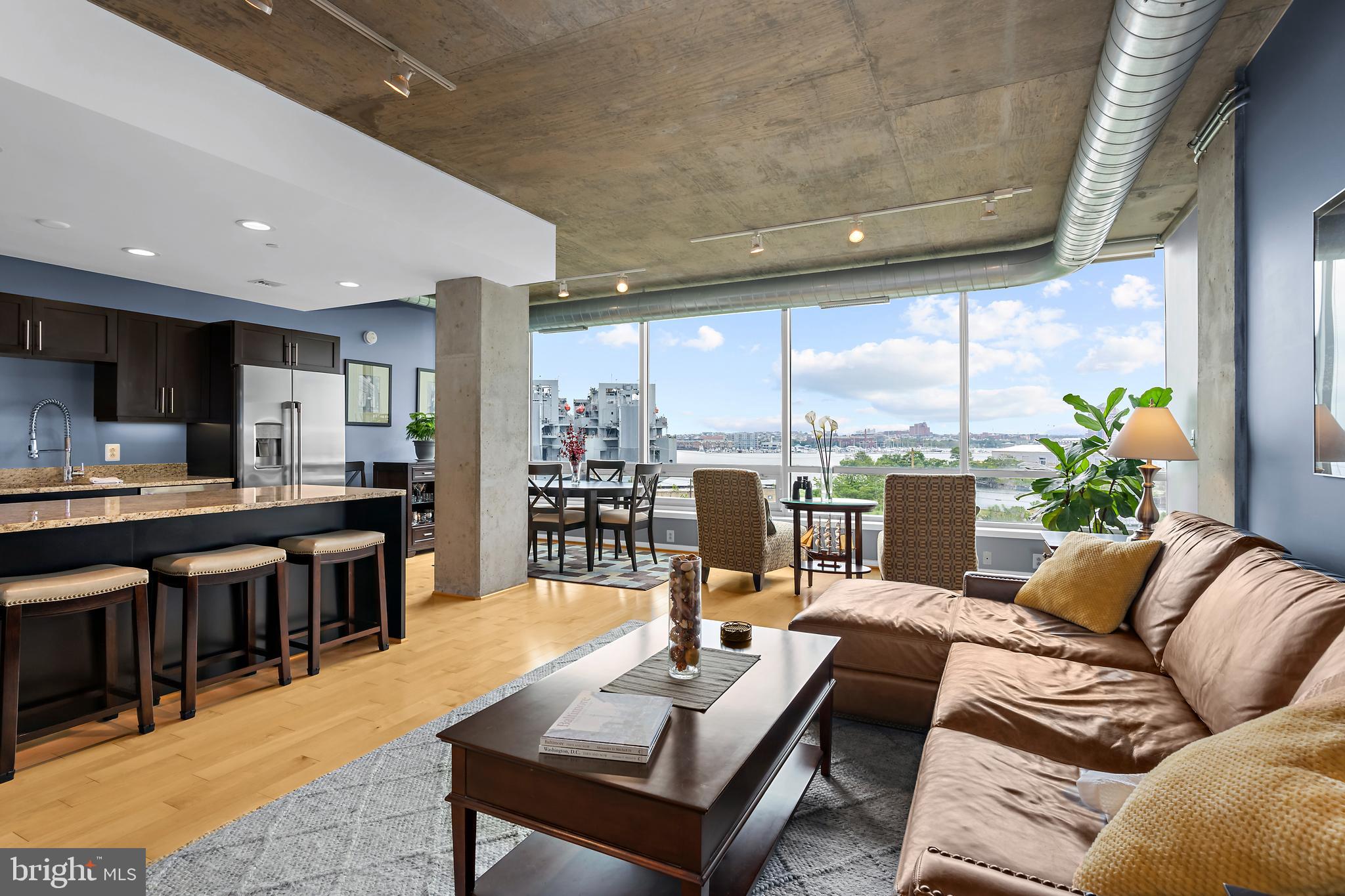 Welcome to waterfront living at its finest in one of Baltimore’s most architecturally celebrated communities. This expansive 1,394-square-foot residence at Silo Point offers a rare combination of modern elegance, generous proportions, and sweeping water and skyline views from floor-to-ceiling windows that span from north to south.
Designed with comfort and style in mind, the open layout connects the main living spaces to a private balcony, perfect for enjoying a quiet morning or entertaining with a view. A chef-inspired kitchen features granite countertops, stainless steel appliances, and abundant cabinet storage. Hardwood flooring runs throughout the home, adding warmth and refinement.
The spacious primary suite is a true retreat with a large walk-in closet and a spa-like bath that includes dual vanities, a soaking tub, and a separate glass-enclosed shower. A stylish powder room provides added convenience for guests while preserving privacy in the main suite.
Additional features include in-unit laundry, extra storage, and two deeded garage parking spaces, an exceptional benefit in city living.
As a resident of Silo Point, you will have access to a curated collection of amenities, including a state-of-the-art fitness center, yoga studio, game and conference rooms, secure bike storage, 24-hour front desk service, and the exclusive 19th-floor Sky Lounge with panoramic views of the Inner Harbor and city skyline.
Set in the heart of historic Locust Point, Silo Point offers unbeatable proximity to Fort McHenry, Baltimore Peninsula, waterfront parks, local shops and dining, water taxi stops, major highways, and BWI Airport