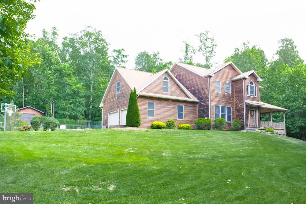 Feel like King of the Hill in this amazing German Wood-sided home on 5+ acres. Enjoy the privacy as you entertain or relax w/Mahogany deck, gazebo, stamped patio & in-ground pool or wander the woods. New carpet in the Living Rm & 2 story family room w/stone fireplace, open floor plan.  Finished LL w/dry bar, wood stove. Geothermal Heat means low utilities, ready-to-fin area above garage w/sep access, side garage, out bldg, ext generator hook-up, new well pump ('16), new pool filter ('16).  A joy to show!
