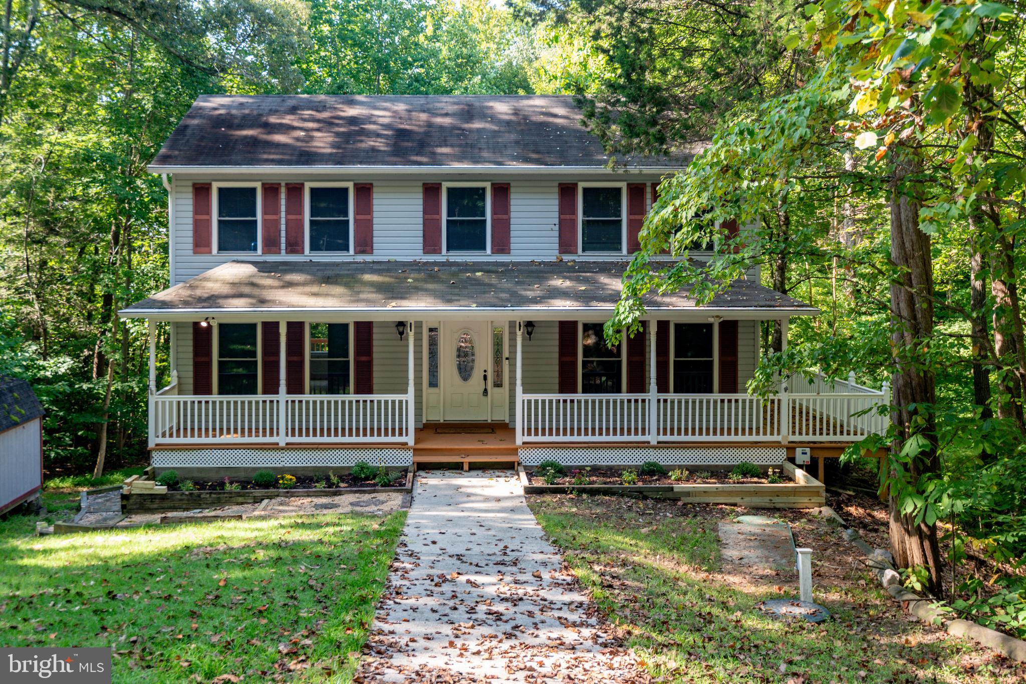 VERY NICE COLONIAL NESTLED AMONG THE TREES IN CENTRALLY LOCATED WHITE SANDS WITH TONS OF PRIVACY. GREAT FLOOR PLAN WITH PRIMARY SUITE, 3 ADDITIONAL BEDROOMS AND A FULL BATH ON SECOND LEVEL. HUGE EAT-IN KITCHEN, LIVING ROOM AND DINING ROOM ... PLUS A POWDER ROOM ON MAIN LEVEL. THE ALMOST FULLY FINISHED WALK-OUT BASEMENT. HAS A SPACIOUS REC ROOM AND A SEPARATE ROOM FOR STORAGE WITH A WORKBENCH. NEW WINDOWS. WRAP AROUND COVERED PORCH. DECK