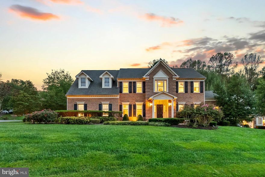 Tucked away on a double cul-de-sac in the sought-after Stoney Creek Woods community and within the Langley school pyramid, this 6,300 sq. ft. home combines refined architectural detail with modern enhancements. Designed with five bedrooms, four full baths, and a half bath, the floor plan balances elegance with everyday livability.

The entry showcases a soaring two-story foyer, opening to inviting formal and casual spaces. Beyond the foyer, the family room captures attention with natural light from overhead skylights and a fireplace framed by a custom stone surround, blending brightness with architectural detail. A sunlit breakfast area, glass-wrapped sunroom, and private office with French doors extend the living space, offering flexibility for both daily routines and entertaining. At the center of the home, the kitchen is crafted for the culinary enthusiast, featuring premium appliances, dual dishwashers, abundant custom cabinetry, and a granite island with seating for gatherings large or small.

The upper level hosts four well-appointed bedrooms, each with hardwood flooring, crown molding, and walk-in closets. The primary suite offers a retreat-like atmosphere with a spacious bedroom, spa-inspired bath with heated tile floors and granite counters, and a generous closet. Secondary bedrooms include en-suite or Jack-and-Jill baths with upgraded finishes.

The walk-out lower level is designed for both comfort and entertainment. Guests will appreciate the private bedroom and full bath, while the exposed brick wall adds warmth and character. A fully equipped bar with custom cabinetry, sink, beverage cooler, and display shelving makes hosting effortless, while the dedicated theater room creates a cinematic experience at home. This level seamlessly combines practicality with leisure, making it an ideal gathering spot.

The backyard serves as a private retreat, bordered by mature trees that provide shade and seclusion. A paver patio offers the perfect setting for gatherings, while the hot tub invites relaxation year-round. Thoughtful landscaping, including fruit trees, enhances the natural beauty of the space. Whether entertaining guests or enjoying a quiet evening, the outdoor areas offer the charm of a private park in your own backyard.

Highlights include a whole-house generator, new HVAC system, skylights, and updated lighting. This home has seen major investment over time, with a full renovation and expansion in 2012 exceeding half a million dollars, and an additional $100,000+ in updates completed in 2024 and 2025 by the current owner.

Stoney Creek Woods offers a rare combination of privacy and convenience. Nestled among tree-lined streets, the neighborhood provides a peaceful setting while maintaining easy access to Tysons Corner, downtown McLean, and major commuter routes. The location is also ideal for recreation and leisure, with quick access to Great Falls Village, Reston Town Center, the YMCA, multiple community recreation centers, pools, and golf courses. Families will also appreciate the placement within the Langley High School pyramid: Forestville Elementary, Cooper Middle, and Langley High School.