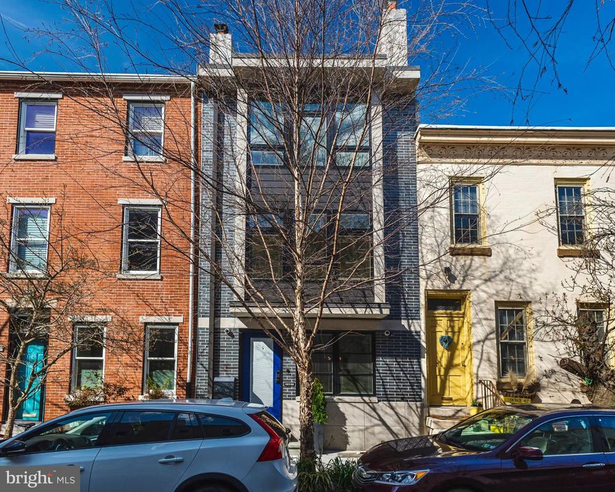 2307 Naudain Street is located on a quiet block and Premier location in FITLER
SQUARE. This home is a rare find, completely upgraded, 4 bedroom, 2.25 bath, with a
fabulous garden and rooftop deck. The contemporary design and open floor plan is functional
and stylish. Enter into a sun-filled living room with large triple pane quiet windows, gas
fireplace, hardwood floors and grand Tower Steel Staircase with floating hickory steps
and handrails. Past the living room is the open kitchen and dining area.  Kitchen has
upgraded appliances, cherry cabinets, light granite countertops and an island with a
large sink and bar stool seating area. Casual everyday dining space warmed with the
light from floor to ceiling windows and door that opens to a beautiful rear garden with
raised planting beds and shrubs. Perfect for Al Fresco dining in warmer months.  The second and third floors have hickory hardwood floors throughout. The second floor consists of two large bedrooms with walk-in closets, hallway bath w/Kohler whirlpool tub, multi-jet shower and black glass counters.  Hallway closet has a stacked LG Laundry System plus linen closet. Third floor w/Independent air condition consists of a Primary Suite in the rear and a den in the front.  The Den has vaulted 12' ceilings, Gas fireplace, Wet Bar, small refrigerator and custom closets.  The Primary Bedroom has a walk in closet, 8 foot doors leading out to a 8' x 3' Balcony. Good for Morning Coffee!!  Primary Bath has Custom dual height vanities, heated towel bar and floors and Spa Shower which includes 17 head 6 function Kohler Konnect shower
system - sauna - rain shower - mist heads, Bluetooth Stereo Sound System and Wifi
connected I-Pad.  RELAX after a long day!! Continue up the grand tower staircase to a
spectacular roof deck that has a salt water 6-person Hot Tub, outdoor multi-head
shower, 32' sky view outdoor TV, 8x8 rotating umbrella which covers hot tub and
seating.   Beautiful Sky-line View of the City. The lower level of the home is sure to
please with Home Gym or office, wine storage, water closet and plenty of
storage. There are numerous up-grades throughout this home including heated
hydronic front sidewalk (snow melt), security cameras, two zone HVAC, heated
hardwood floors and many more. An ideal Fitler Square Location, just a few blocks from
the PHILADELPHIAN SCHOOL and in the Greenfield Catchment.  This home is a short
commute to University Penn, CHOP, Drexel University and Amtrak’s 30th Street
Station. Steps from Fitler Square, Rittenhouse Square, local parks, restaurants, cafes,
tennis courts, Schuylkill Banks Trail, dog park and public Transportation.  A MUST
SEE!!!