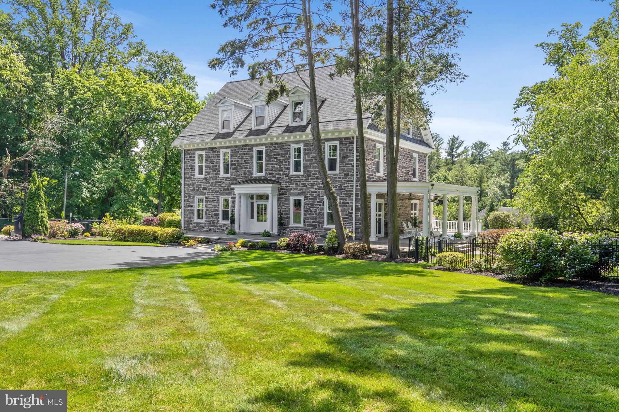 Welcome to 270 Curwen Road, "Bryn Leigh," a classic stone Main Line manor home, that has been updated for todays family life. The 8 bedroom, 5.5 bath home, has the timeless details and quality craftsmanship of the traditional Main Line- 11 ft ceilings on the main floor, and 10 ft ceilings on the 2nd and 3rd floors, 13" high baseboards throughout the home, arched doorways with custom mill work and trim, mahogany built-ins, 15" deep windowsills throughout, 5 fireplaces, hardwoods throughout, and double french doors that lead out to a classic flagstone wrap-around porch, that will entice you to sit outside for hours. The Kitchen is grand in size and updated with abundant custom cabinetry, stainless Sub-Zero refrigerator, a second "vegetable" sink, Dacor 6 burner commercial range/oven, a 2nd stainless Dacor wall oven, oversized center island seating 6, french door to a seated patio area, and back stairway that leads to a nanny/in-law suite with its own entrance. The Living Room and Family Room each have custom built ins, glorious windows and doors to the outside, for perfect entertaining flow. Many school fundraisers have been held in this home! The Dining Room has a FP, exquisite wainscoting and the largest bay window with abundant light. The 2nd floor features a huge master suite with 2 fireplaces, windows galore, master bath and new custom walk-in closets and dressing room. The second floor hosts another en-suite Bedroom, Office, Full Bath, and 2nd floor Laundry Room. The 3rd floor has 5 additional, gracious bedrooms and 2 more full baths, all with 10 ft ceilings. There is also a secret room behind a bookcase, and a secret passageway for the kids to play. The lower level has an oversized Mudroom, Exercise Room, Movie Room, open area/playroom, and tons of storage space. The meticulously landscaped grounds enclose the property with colorful plantings, flat grassy areas and a vacation-like in-ground pool and spa with waterfall. The homeowners have taken all the risk out of buying an older home for you, because they have updated and replaced almost everything: new roof 2019, refinished hardwoods, new HVAC, new plumbing, new electric, tied the house into public sewer, replaced 53 windows, new french doors, new laundry room, kitchen, carpeting, replaced pool systems, finished basement. "Bryn-Leigh" has been loved and maintained in every way, and is ready for the next generation of owners to love and care for it.