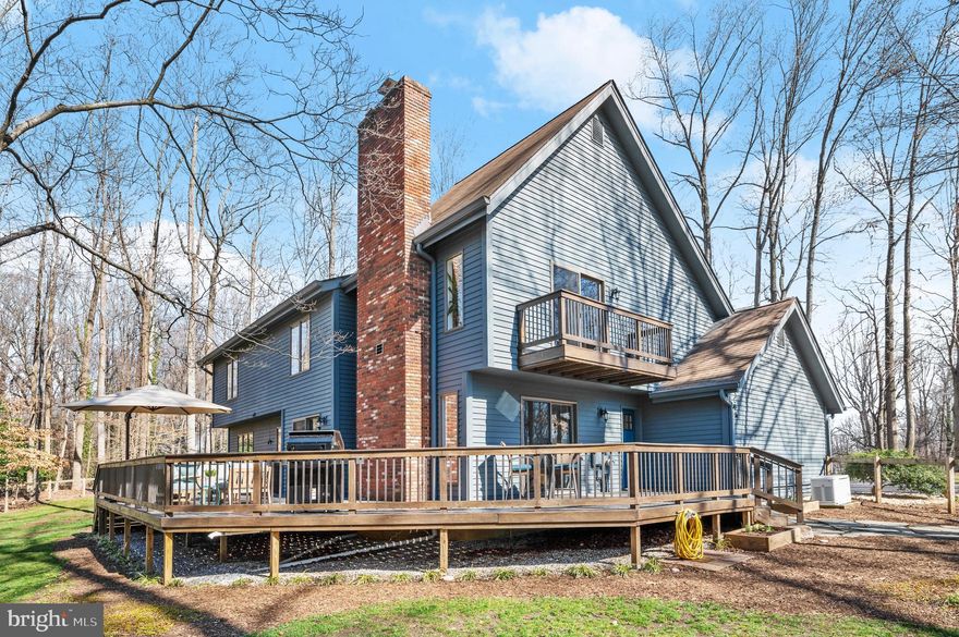 Enjoy the best of town and country in this stunning home, nestled on a private 1.6 acre cul-de-sac corner lot. Boasting picturesque views year-round, along with an abundance of updates throughout, this home surely won't last. Enter past the inviting front porch and step inside where you will find an open concept layout, generous entertaining space and easy access to the best part of this home- the backyard. Easy living awaits in your renovated kitchen appointed with stainless steel appliances, center island and breakfast area, and sleek cabinetry. Off the kitchen, a cozy family room showcases an ambient fireplace, while a separate dining room and recreation room offer additional space for larger crowds. Upstairs, a lavish primary suite presents a private balcony, fireplace, custom walk-in closet and an upgraded en-suite bath. Down the hall, a loft overlooking the recreation room makes for an ideal office (easily converted to 4th bedroom), while the updated guest bath and two sizable bedrooms complete the sleeping quarters. Transition through the Anderson sliding glass doors to the outside to truly bask in the serenity of your new home as you enjoy the tranquility of nature from your vast wrap-around deck, forgetting the hustle and bustle of the flourishing capital. Nearby, you can also relish nature's beauty at Sandy Point State Park and Broadneck Park only minutes away. For additional recreation, entertainment, and shopping and dining, convenient commuter routes US-50 and MD-450/MD-2 allow easy access to Kent Island, Historic Downtown Annapolis, Westfield Mall, the Naval Academy, and more. Whether you prefer the city or the suburbs, you can truly have it all with this home.