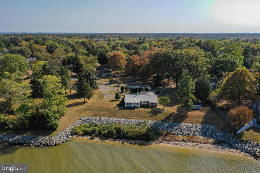 Potomac River Water View!  Dining, kitchen, living room & front bedroom/office are all designed to take advantage of the wide water view.  This comfortable single story home is situated in a quiet spot with golf cart access to all the town amenities.   Convenient garage parking plus paved drive with extra room for trailers.  Features metal roof installed 2016, hardwood flooring, ceramic tile, propane fireplace and enclosed porch overlooking the river.  Must see!