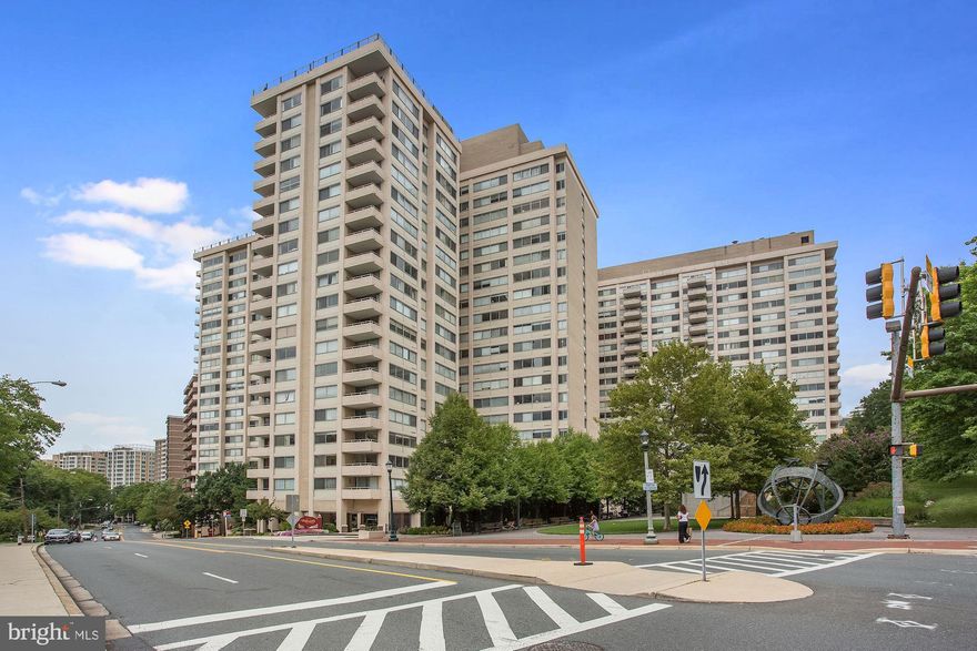 Rarely available 2BR/2BA corner unit on one level at the sought-after Willoughby residences in Chevy Chase, MD. This home offers roughly 1,326 square feet of living space and is flooded with natural light from the wall-to-wall oversized windows. Features include a tiled foyer, large living room with gorgeous hardwood floors and access to private balcony perfect for dining al fresco, formal dining room with large storage room, dual-entry gourmet kitchen with breakfast bar open to living area has gas range, white shaker-style cabinets and plenty of (granite) counter space for any chef.  Both bedrooms offer tons of space and storage with the Owner's suite including an en-suite bath with maple cabinets, glass-top vanity, dressing table and walk-in glass doored shower. Second full bath in hallway for guests. Unit has shared storage unit conveniently located in hallway on the same floor.  One-car garage parking conveys. Condo fee includes ALL utilities. Building amenities include rooftop pool, sun deck, fitness center, 24/7 concierge, secured entry, library, party room, and in-building mini market. Location is is just steps away from Whole Foods, Friendship Heights Metro, upscale retail shopping and dining options. Free building shuttle to Metro and shopping!