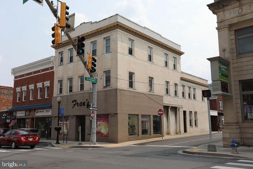 PRIME COMMERCIAL LOCATION!  Located on the corner of Main Street and Broadway, this historic building wrapped in display windows is full of opportunities!  Possibility of TWO commercial spaces on the first floor (one entrance on Main St and one entrance on Broadway).  Five one bedroom/one bath apartments on the 2nd and 3rd floors bringing in $700-$750/month each.  This is a rare opportunity for location, location, location!

Basement and first floor heated with Gas Forced Air (new furnace in 2022).  Upper floors heated with Coal.  Possibility to convert.  Estimates available upon request.