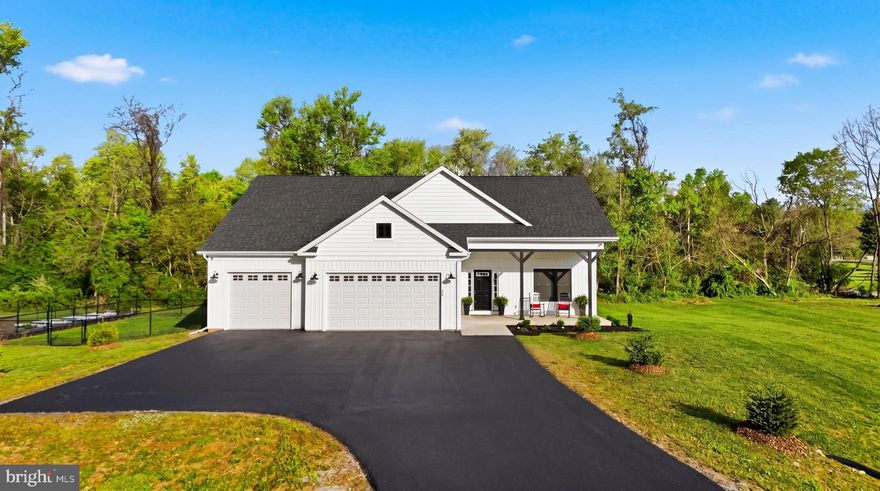 Discover the charm of this beautifully crafted Craftsman-style home, nestled on a serene 2-acre lot with no HOA and no restrictions in a peaceful rural setting. The kitchen features quartz countertops, stainless steel appliances, and a spacious island with a gorgeous farm sink, making it a culinary enthusiast's dream. With three well-appointed bedrooms and three full bathrooms, including a luxurious primary suite with a soaking free standing tub and walk-in shower. This home places comfort and convenience at the fore front with recessed lighting and ceiling fans throughout.  Relax in the spacious great room while enjoying the cozy feel of the gas fireplace. The main floor laundry adds to the ease of daily living. Step outside to find a lovely front and rear porch, ideal for enjoying morning coffee or evening sunsets. The partly wooded lot offers a tranquil backdrop, with landscaping and extensive hardscaping that enhances the natural beauty of the surroundings along with a fenced area for pet protection and a raised, irrigated garden system that is fully fenced. The attached three-car garage provides ample space for vehicles and storage. This home is equipped with modern security features (8 Lorex cameras), ensuring peace of mind.  Located on a no-thru street, this property offers privacy, making it a perfect retreat from the hustle and bustle though it's just minutes to DMV commuter routes. Experience the perfect blend of modern living and natural beauty in this exceptional home.