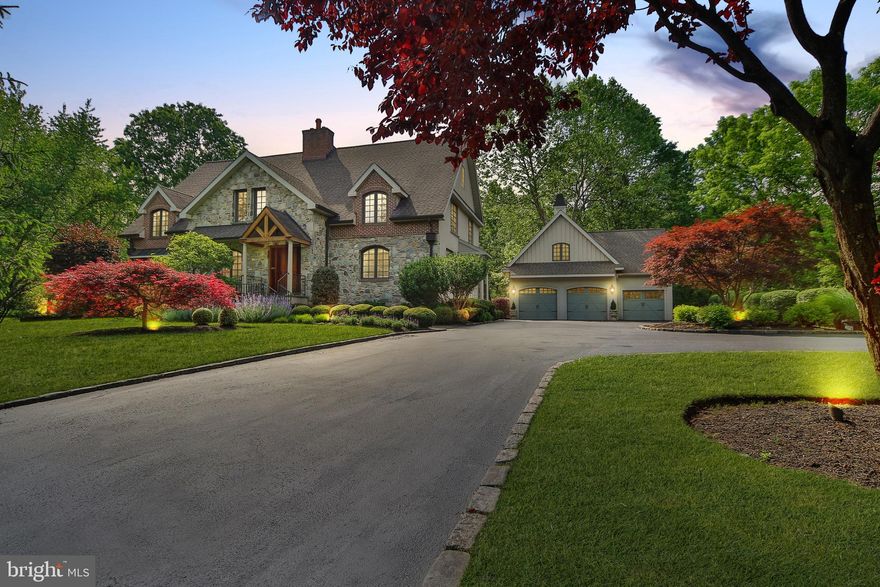 NEW LOOK for this fabulous home! Freshly painted first floor and virtually staged! *$100,000 PRICE IMPROVEMENT!* Exquisitely designed from the ground up by Rene Hoffman, this stunning 5 BR, 5 full, 2 half bath stone colonial offers comfortable living combined with unparalleled attention to detail. From the moment you enter the front door, you will notice the beautiful hardwood floors, crown molding and wainscoting, plantation shutters, abundant recessed lighting and surround sound throughout the main level. The gracious Living Room features a coffered ceiling, raised hearth gas fireplace and built-in bookshelves. The adjacent Dining Room, with bay window offers plenty of room for holiday dinners. Between the LR & DR is a perfectly situated wet bar, with cherry cabinets, granite countertop and dual zone Sub Zero wine fridge. The gourmet Kitchen is a chef s dream, with cherry cabinets, granite countertops, tumbled marble backsplash, Kohler farm sink, Thermodor cooktop and double oven, Sub Zero refrigerator, Bosch dishwasher and GE Profile microwave. The adjacent Butler s Pantry offers additional cabinets and a second Bosch dishwasher. The breakfast area opens to the Family Room, with built-in cabinetry and access to the large deck with views of the wooded backyard and pond. A cozy Study, Powder Room, Laundry and Mudroom complete the first floor. The second floor, with hardwood floors, recessed lighting and plantation shutters throughout is accessed by front and back stairs and features an expansive Master Suite   a spacious Bedroom with tray ceiling and gas fireplace, 2 walk-in closets and spa-like Master Bath with double vanity, whirlpool tub, separate water closet and large stall shower with rain head. Three additional Bedrooms   2 with en-suite Baths, a hall Bath and multi-purpose Loft area complete the second floor. The third floor offers a large 5th Bedroom or additional living space with en-suite Bath. The full, finished walk-out Basement is perfect for entertaining, with a large living area with built-in cabinetry and gas fireplace, game area with pool table and wet bar, gym, half bath and plenty of storage. A detached 3 car Garage with storage above completes this special property. Perfectly located near Germantown Academy, transportation and the restaurants and shopping of Ambler, Springhouse and Chestnut Hill. One Year Home Warranty.