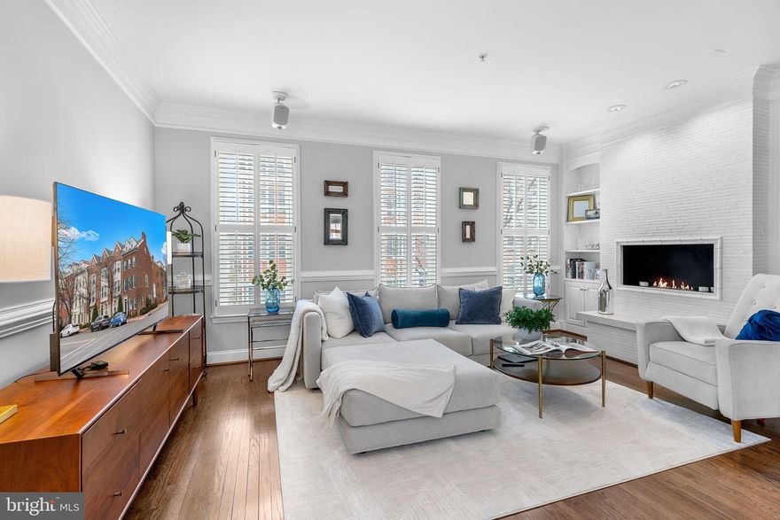 Old Town Alexandria — Timeless Charm Meets Modern Luxury. Welcome to this 3BR + Den /3.5BA beautifully renovated townhouse just 3 blocks to the waterfront. The 4-level end unit is filled with warmth, character, and thoughtful update — from the rich oak hardwood floors to the intricate designer tile work and custom solid-wood plantation shutters on every window.  The entry level features a den/office, half bath, and access to your attached 2-car garage — a rare find in Old Town, and it includes a 220V charger for your EV! The elegant main level boasts a light-filled, open living and dining room, with large windows, crown molding, chair rails, and a ventless fireplace. Double French doors open to gourmet eat-in kitchen with Mouser cabinetry, stainless steel appliances, and gorgeous counter tops. Sliding doors lead to Trex-style deck. The upper level boasts 2 bedrooms and two baths, both with walk in closets. The luxurious primary suite is your private retreat, complete with spa-inspired bath and heated floors. The spacious third ensuite bedroom on the top floor can double as a family/media room and includes recessed lights and vaulted ceilings. Meticulously maintained and thoughtfully updated, this townhome is just blocks to Alexandria’s waterfront, bustling King Street, the growing Oak district – all offering an incredible mix of local shops, restaurants, and cafes.  Easy access to the King Street Metro, Washington DC, Reagan National Airport, GW Parkway and I-495/95, makes this home perfect for commuters