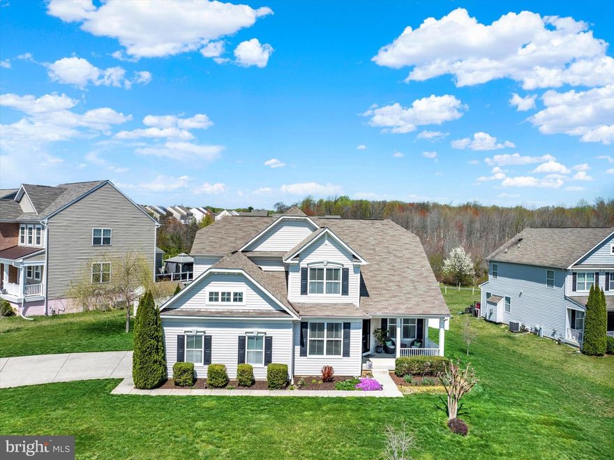 Welcome to this beautiful single-family home nestled in a quiet cul-de-sac in the desirable Beechtree Estates community! From the moment you arrive, the charming covered front porch invites you in. Step inside to a welcoming foyer with gleaming hardwood floors, leading to a private home office with built-ins, a powder room, and a spacious formal dining room adorned with crown and chair rail moldings.

The heart of the home is the gourmet kitchen, boasting granite countertops, pendant lighting, stainless steel appliances, an abundance of cabinets and counter space, a pantry, and a large eating area with room for a table plus breakfast bar seating. Sliders off the kitchen lead to a maintenance-free deck with awning, paver patio, and fenced backyard—perfect for relaxing or entertaining.

The kitchen opens to the living room with soaring vaulted ceilings, a gas fireplace with stone surround and mantle, and additional built-in shelving. The main level laundry room includes cabinets, a built-in bench with hooks, and a washer/dryer.

Also on the main level is the spacious primary bedroom suite featuring a walk-in closet with organizer and a luxurious en-suite bath with dual sinks, a large walk-in shower with dual shower heads, a private water closet, and a linen closet.

Upstairs, you’ll find three generous-sized bedrooms and a full hall bath. The expansive unfinished basement, with walkoout stairs to the backyard, offers endless possibilities for your personal touch.

Enjoy all that Beechtree Estates has to offer, including a community pool, clubhouse, fitness center, walking trails, and playgrounds. A perfect blend of comfort, style, and community—don’t miss this one!