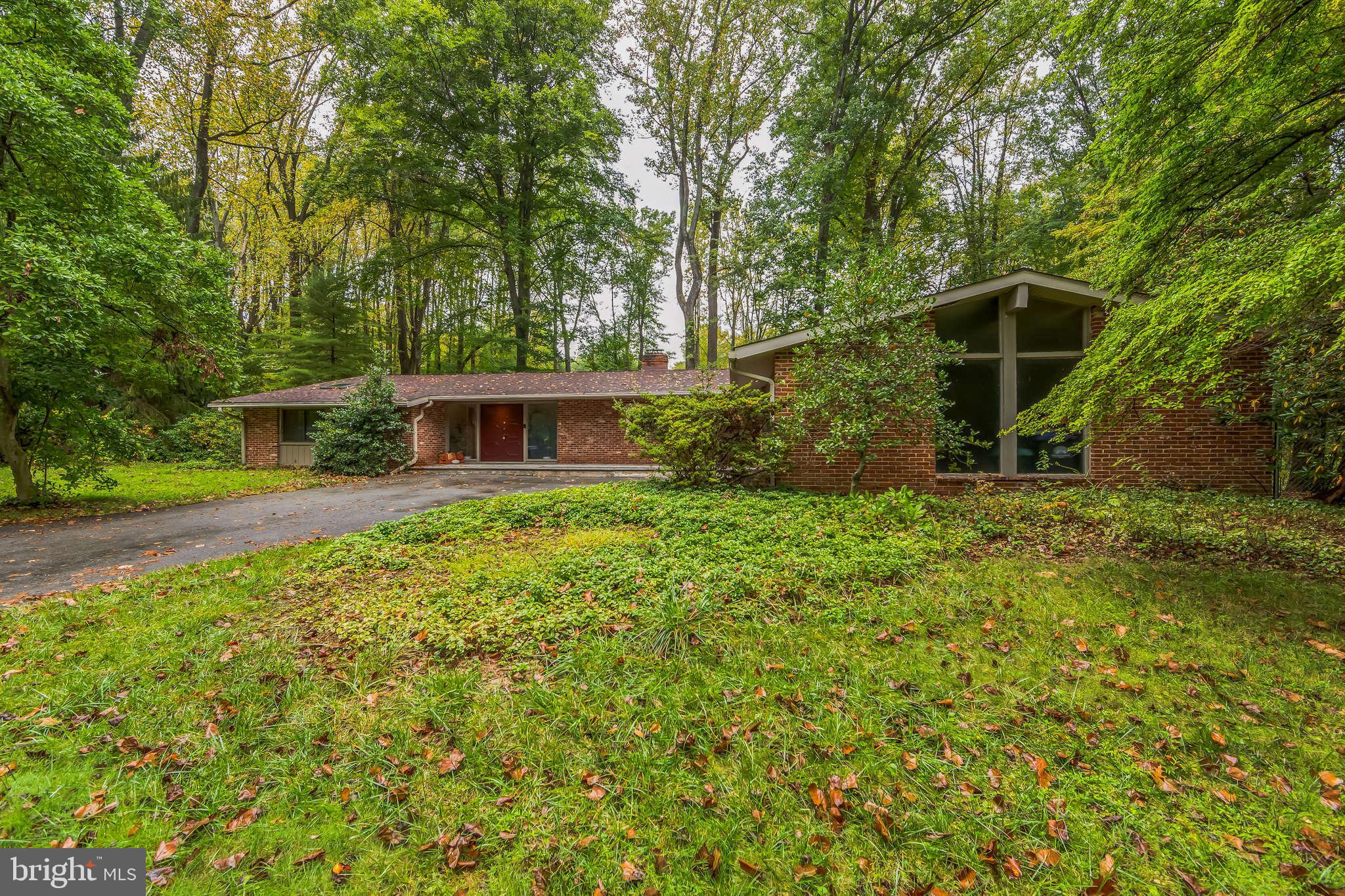 This 1960s contemporary rancher exudes retro charm with modern touches, offering a spacious, open layout ideal for both living and entertaining. Upon entering, the eclectic foyer welcomes you with unique lighting and mid-century flair, leading into a sprawling living area through a wrought iron gate. This is accentuated by high ceilings and expansive picture windows that flood the space with natural light. The great room wraps around to dining area/game room that overlooks enormous patio to pool. Two master bedrooms, each with its own ensuite bath and private access to patios, provide luxurious privacy, while the additional two bedrooms share a full bath, perfect for family or guests. Stunning hardwood floors throughout most of the home adds timeless beauty and elegance. The kitchen is a chef’s dream, boasting ample counter space and cherry cabinetry, connecting seamlessly to another eat-in/entertaining area with sliders to patio #2. The outdoor spaces are a sanctuary, complete with numerous lounging spots, perfect for soaking up the sun or hosting gatherings in style. The lower level is partially finished for gym/entertaining or the enthusiastic hobbyist. This home has all the privacy you need while being close to shoppes, restaurants, Rt. 30 bypass and so much more.