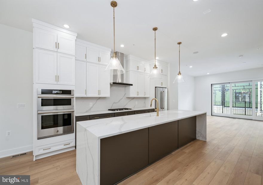 This elevator-equipped luxury townhome is truly stunning, thoughtfully designed with high-end touches throughout. The entry-level features a versatile bedroom - perfect as a guest suite, home office, or private retreat. On the second floor, you'll find a spacious, open-concept layout that seamlessly connects a chef-inspired kitchen, generous dining area, and an expansive great room—ideal for entertaining. A walk-in pantry and access to a covered deck complete the kitchen space, combining function and style. Upstairs, the third level offers two expansive primary suites, each with ample closet space and elegant ensuite baths, providing comfort and privacy. Take your private elevator all the way to the rooftop terrace, a true showstopper, featuring a retractable awning and cozy fireplace—perfect for year-round relaxation or hosting under the stars. Best of all, our design team has carefully hand-selected every finish, fixture, and material to reflect a sense of effortless luxury. From rich textures to refined color palettes, each choice is made to elevate the space and create a warm, sophisticated atmosphere that feels both timeless and uniquely personal. All this, just minutes from the premier shopping, dining, and vibrant energy of Chevy Chase, Friendship Heights, and Washington, D.C.