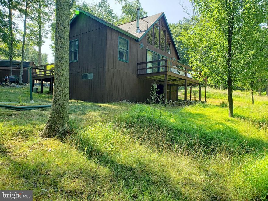 Simply Adorable! Well maintained chalet on private wooded 4.182 acres. Make this your private little get-a-way or permanent residence. Sit out on the decks and enjoy the peaceful and private  surroundings, cozy up to the wood stove on those chilly evenings. Large shed and two storage areas beneath house. House built in 1986 but was just the shell until current owners purchased in 2004. House was completed inside between 2004 and 2006 and has been their permanent residence for the past 13 years. Conventional septic system.