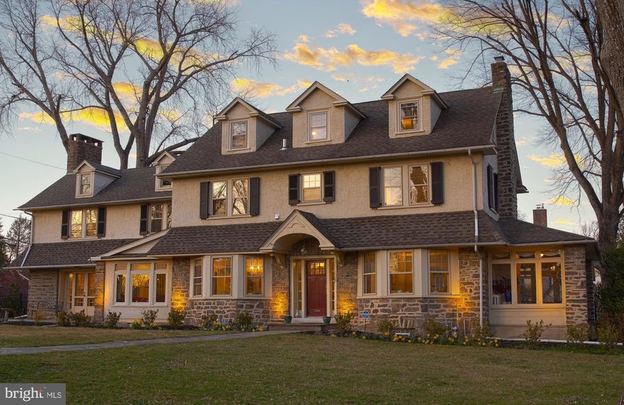 PRICE ADJUSTMENT - Stunning stone/stucco colonial on a large, beautiful tree lined corner lot in the desirable Jenkintown Manor neighborhood. Offering unparalleled charm, great sunlight, and modern comfort. With exquisite woodwork throughout, original inlaid hardwood floors, high ceilings, and three fireplaces, this residence offers the perfect blend of old-world charm and sophisticated living.  The heart of this 6-bedroom, 4.5 bath home is a NEW spacious, gourmet kitchen addition with vaulted ceilings. Cooks will love the kitchen and butler’s pantry with the plentiful Amish craftsman cabinets. It boasts granite countertops, a large center island, stainless appliances and 2 farm sinks. There is also a beverage bar with sink and instant hot water dispenser, and a large walk-in pantry. The eating area with large windows overlooks the large (40’x16’) new flagstone patio and spacious fenced back yard (accessible from the kitchen or mudroom).  Gracious living & entertaining spaces on the first floor include the formal living room with a wood-burning fireplace with marble mantle and front bay windows.  A lovely, heated sunroom with 3 walls of windows flows from the living room.  The formal dining room with front bay windows leads to the kitchen or a cozy den/playroom with many windows. The 20’ x 20’ family room has a gas fireplace with a marble mantle and French doors leading to a front flagstone patio, windows along the rear wall, and 2 large closets.  A half bath and mudroom complete the first level.  With six bedrooms, this home offers plenty of space for relaxation, privacy, home offices, home gym, and more. The primary bedroom includes a new enSuite bathroom finished in elegant tile and granite. Two additional bedrooms are on the second floor along with a ceramic tile full hall bath, while another bedroom is adorned with a stone wood-burning fireplace flanked by bookshelves and an enSuite updated bathroom. The back staircase (near 3 hall closets) leads to the mudroom and butler’s pantry, adding to the home's character. Two additional bedrooms (one with adjacent attic storage) are on the third floor, share an updated bathroom, and have large closets. The laundry is located conveniently on the second floor. 

Major investments were lovingly made by the current owners (including the new kitchen and master bath, upgraded electrical (no more knob & tube), professional landscaping, and generator hook-up). There is a 3-car garage with abundant attic storage. The unfinished basement features built-in shelving units and plenty of storage area. This home has multiple air conditioning zones.  A second patio is attached to the 3-car detached garage.  Exterior landscape uplighting adds a beautiful touch at night to the front of the house. Special touches include crystal doorknobs, solid wood doors, and original window glass.  A whole house Generac generator is an added feature.   A Rare Opportunity in one of the most sought-after locations and communities in Montgomery County, this home offers a perfect balance of convenience and beauty. Abington was named the “24th best place to live in the United States” by Money Magazine in 2022-2023. Located in the Award-Winning Abington School District (McKinley Elementary), and minutes from two train stations (20 minutes to center city) and many hospitals. Short walks to Alverthorpe Park, the Abington Golf and Fitness Club, fine dining, and shopping. This is more than just a home— don’t miss this rare opportunity to join the Jenkintown Manor neighborhood. Schedule your private tour today! Don't wait!!
