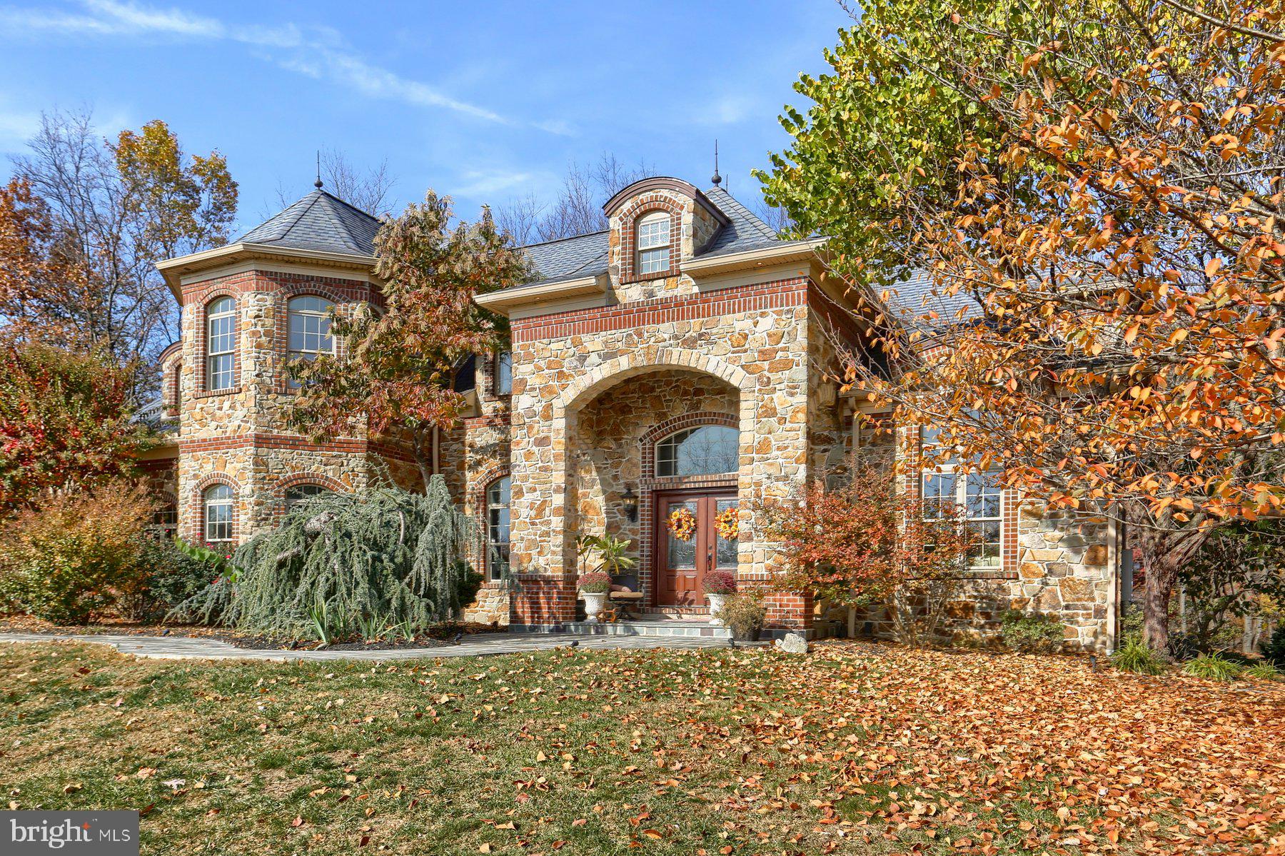 Welcome to this stately home in the prestigious Pinehurst Hills community! This custom-built beauty has had only one owner and has been impeccably cared for and maintained. This home boasts over 5,000 square feet of gorgeous living space, high-end finishes and even a few surprises like the ‘secret door’ leading from the kitchen to the back staircase and spacious laundry and mudroom. Upon entering through the double front doors, you will find yourself in the grand foyer with a curved and sweeping staircase. To your left is a formal dining room with double tray ceilings and space big enough to host the most special and memorable occasions. On your right is a sun/living room glimmering with natural light. Moving through to the back of the house is a beautifully appointed family room surrounded by transomed windows, a gas fireplace, built-ins, expansive crown molding and distinctive millwork, Brazilian cherry hardwood floors, a gorgeous custom bar topped with a slab of finished black walnut complete with a live edge, glass tile backsplash and wine cooler. The French doors lead to the inviting covered patio with ceramic tile floors overlooking the private backyard filled with trees, gardens, and mountain views. The heart of this home is the gourmet chef's kitchen equipped with tons of recessed lighting, cherry cabinets, a huge granite island and peninsula both boasting enough room for numerous stools for casual gathering and dining. Tile backsplash, intricate molding, arched doorways, a one-of-a-kind tile mosaic behind the stove, tons of cleverly designed storage, GE Profile double oven, five-burner Thermador gas cooktop, and the most spectacular dining space adjacent to the kitchen in the turret which means charming, curved walls. This family room/kitchen/dining space in the back of this home is the ultimate entertainment and gathering place! Rounding out the first floor is a private, large bedroom with a wall of curved windows and full bath which could be room for the in-laws, guest space, or with a few tweaks a first floor primary. Upstairs, you’ll find three additional bedrooms, two full bathrooms (one is a jack and jill!) and the primary suite which could be your private shangrilah! Luxury only an abundance of space can provide, this primary bedroom includes a three-sided fireplace, sitting area, and walk-in closet one could get lost in! The en-suite bathroom’s fully tiled shower is big enough for you and five of your closest friends! In addition, there’s a large soaking tub, heated floors, ‘his and her’ vanities with extensive custom cabinetry, storage galore! But wait, there’s more! The huge finished walk-out basement offers an additional bedroom for guests, a full bath, recreation room, home gym, and more storage than you could possibly fill. A four-car garage, central vacuum, whole house generator…this very special property is more than a home, it is a private sanctuary where you can enjoy security, privacy, and every comfort imaginable. See yourselves entertaining and making memories here for years to come! Located within the Cumberland Valley School District, this home’s location offers easy access to major highways and proximity to shopping, dining, theatre, music, and nature! A spectacular place to call home...don't let this one get away!