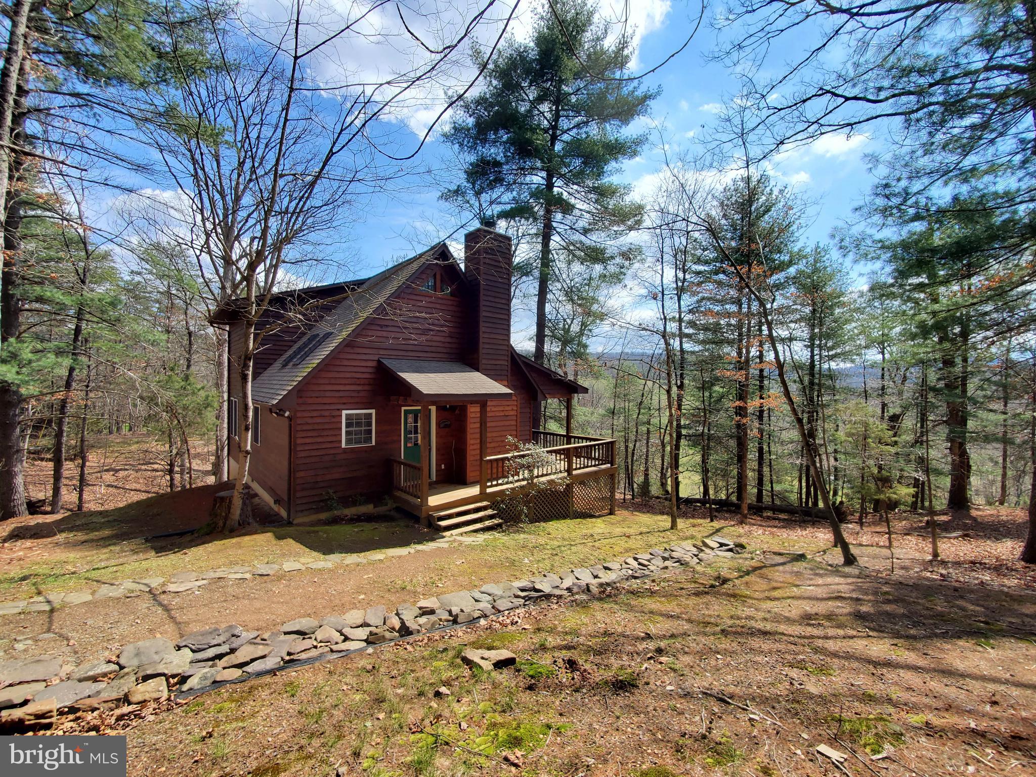 Welcome to Pond View Cabin! This home was custom built to maximize outdoor and indoor living space to enjoy the natural beauty of the mountains. The property has both water and mountain views that can be enjoyed from the wrap around porch or private second level balcony. The natural sunlight fills the open concept living space on the main floor with its multiple skylights, glass door and windows to the walk around porch. The statement piece of the living room is the floor to ceiling stone wood burning fireplace. The open concept main level is ideal for entertaining family and friends. The cabin boasts wood floors, wood vaulted ceilings and wooden beams and ceilings in the bedrooms and hallway on the main level. There is a private master bedroom and master bath on the second level. The master bedroom also has vaulted ceilings and its own private balcony to enjoy the water and mountain views. The cabin has been very lightly lived in due to this being a second home owned by only one family since construction. The property is not in a subdivision and is unrestricted!