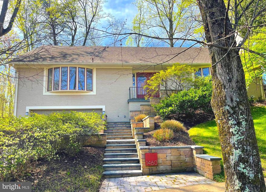 Welcome to this very special home tucked away on a large private property in sought after Chain Bridge Woods.   So much larger than it appears with over 5,100 estimated square feet of living space on three spacious levels.   The main level features a sun-filled Living Room with fireplace and commanding bay window, as well as a very large and sun-filled Study with built-ins & full baths, making this the perfect Main Level Bedroom Suite.   A central Kitchen features granite & Stainless-steel appliances and a charming Breakfast Nook.  The kitchen adjoins a main-level Family Room with built-ins and a fireplace.  There is a formal Dining Room with a stunning light fixture and french doors opening to a gorgeous stone Patio with a Pergola & large landscaped and fully fenced yard and gardens!  A tranquil and lush oasis, completely private and perfect for a morning cup of coffee or a peaceful evening glass of wine. The upstairs also has four large bedrooms w/ hardwood floors, including a spa-like Primary Suite with a Zen-like sense of elegance. The lower level is equally spacious with a second Family Room with a fireplace and Wet-Bar and a large Recreation Room with Built-ins, perfect for a pool table.  The lower level also has extensive storage options, a nice half-bath and access to the two car Garage.  The home has a special feel of privacy and exclusivity and is tucked away in a beautiful and sought-after area of Chesterbrook.  The neighborhood offers easy access to pool clubs, multiple parks and nature trails leading to the Potomac.   A short drive into north Arlington and DC, with close proximity to Tysons Corner make this the perfect location in McLean.  Come visit our open houses this Saturday and Sunday!