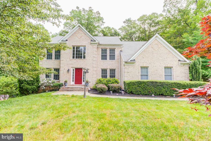 Don’t miss this gorgeous well maintained Custom Brick front colonial on 1 Acre Wooded Lot. The main level welcomes you with a 2-story foyer, crown molding, office/study and formal living/dining rooms with wood floors. The updated kitchen has plenty of lighting, ceramic floors, granite counters, center island, gas range, pantry, and sunroom area with walkout to the deck.  There is a main level laundry and mud room.  The well-appointed 2 Story family room has a woodburning fireplace and is wonderful for relaxing after a long day. Upstairs you will find an expansive master bedroom suite and enormous walk-in closet. The light filled updated luxury master bath has a soaking tub and separate shower. Additionally, there are 2 additional bedrooms upstairs and remodeled bath.  Head downstairs to the finished basement where you will find a rec room space for additional entertaining, 3 additional rooms that can be used as bedrooms/den (no window), full bath, large storage room and walkout to the fenced back yard with playset.   Freshly Painted. Zoned for Colgan HS, Benton MS and Coles Elementary.  No HOA! Public Water/Sewer and 2 Zoned HVAC