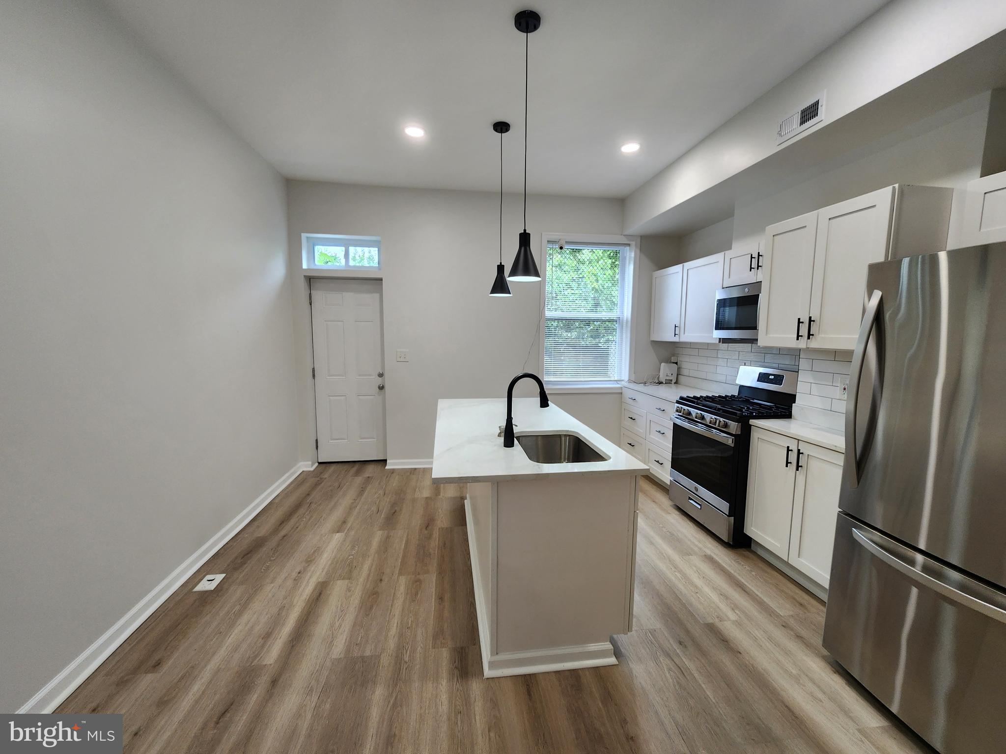 Come see this totally renovated spacious light filled home in near historic Madison Park. This gem has recessed lights in its tall ceilings that accents perfectly the new floors throughout. The stainless steel appliances glow in the modern style kitchen that boasts an open floor plan. Enjoy the large lower level in the winter time or relax in the huge courtyard in the rear with its concreted parking pad. Ground rent unknown seller will not redeem.