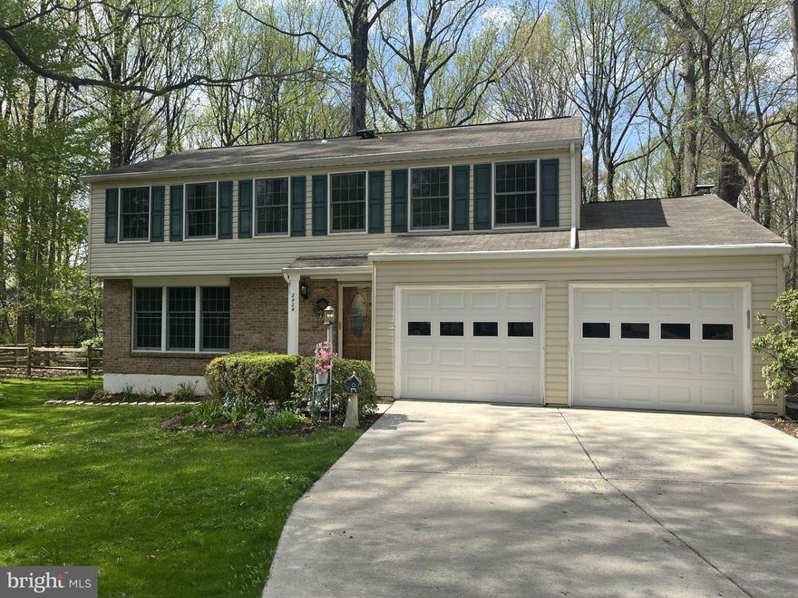 Discover the space, setting, and lifestyle that Reston is known for in this charming colonial nestled among mature trees. Thoughtfully designed for everyday family living, this home offers four spacious bedrooms, two full baths, and a comfortable layout with room to grow. The inviting family room, anchored by a classic brick fireplace, flows seamlessly into the dining area—perfect for gatherings, holidays, and relaxed evenings at home. The updated kitchen features granite countertops, new stainless steel appliances, and new backsplash to show off your cooking skills. Sunlight fills the home through large patio doors, highlighting hardwood and durable vinyl flooring throughout. Upstairs, the primary suite provides a private retreat with a beautifully updated glass walk-in shower and generous closet space. A partially finished daylight basement adds valuable flexibility—ideal for a playroom, home gym, media space, or additional storage. Set on a generous 0.36-acre lot with front, side, and rear yard areas that backs to trees, the outdoor space offers room for kids, pets, and entertaining. Enjoy everything Reston has to offer, including scenic lakes, pools, tennis courts, trails, and community centers that support an active, family-friendly lifestyle. Updates include fresh interior paint, new stainless steel kitchen appliances, new HVAC compressor, recessed lighting, granite countertops, and an upcoming installation of $70K in Andersen Windows—a major value add for comfort and efficiency. Complete with a two-car garage, ample driveway parking, and easy access to major commuter routes, Metro, and shopping destinations like Reston Town Center and nearby retail hubs, this home offers the perfect balance of tranquility, convenience, and long-term potential.
