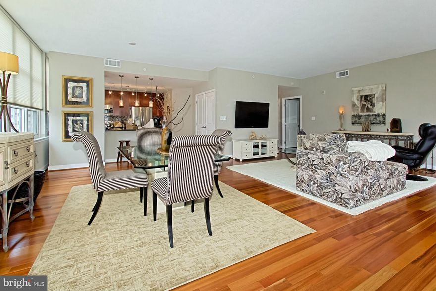 Absolutely Stunning corner unit, 2 BR & Den contemporary condo. The epitome of luxury w/over $50,000 of upgrades. Sunlight drenched rooms w/walls of windows, highlighting wood floors throughout. Gourmet kit w/custom tile backsplash, stainless apps & granite counters. Balcony w/Potomac views, custom closets, SOMFY blind system, upgraded lighting & more. 2 garage. Walk to shops, water & restaurants.