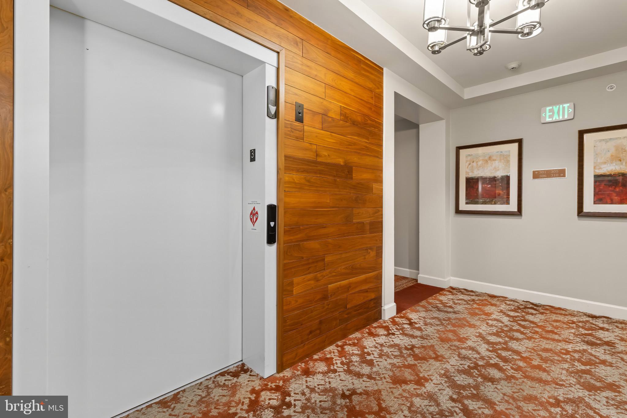 Elegant top-floor rear corner condominium built in 2018 offering 1,552 square feet with 2 bedrooms and 2 full baths in the sought-after Vantage Condominiums, perfectly positioned to capture sweeping views of the 7th fairway of the Turf Valley golf course. A spacious foyer with hardwood floors welcomes you into the impressive open-concept living area, beginning with a formal dining space that flows seamlessly into the inviting living room, complete with plush carpeting, a cozy electric gas fireplace, and access to the covered balcony. The stunning eat-in kitchen blends style and function, showcasing hardwood floors, quartz countertops, white shaker-style cabinetry with under-cabinet lighting, a contrasting wood oversized island with breakfast bar seating, pendant lighting, stainless steel appliances, a marble subway tile backsplash, and a generous pantry. Down the hallway, a convenient laundry closet adds ease to everyday living. The two carpeted bedrooms include a luxurious primary suite with a walk-in closet enhanced by a custom organization system and a private bath featuring dual vanities. The second bedroom includes two closets, while a full hall bath serves both guests and residents. Step onto the covered balcony to relax and take in the tranquil Hialeah golf course views. Additional features include a 1.5 car private garage with direct access to building lobby and elevator through the common garage. Residents also enjoy the convenience of being close to Turf Valley Town Square, offering dining, shopping, and everyday amenities just minutes away.