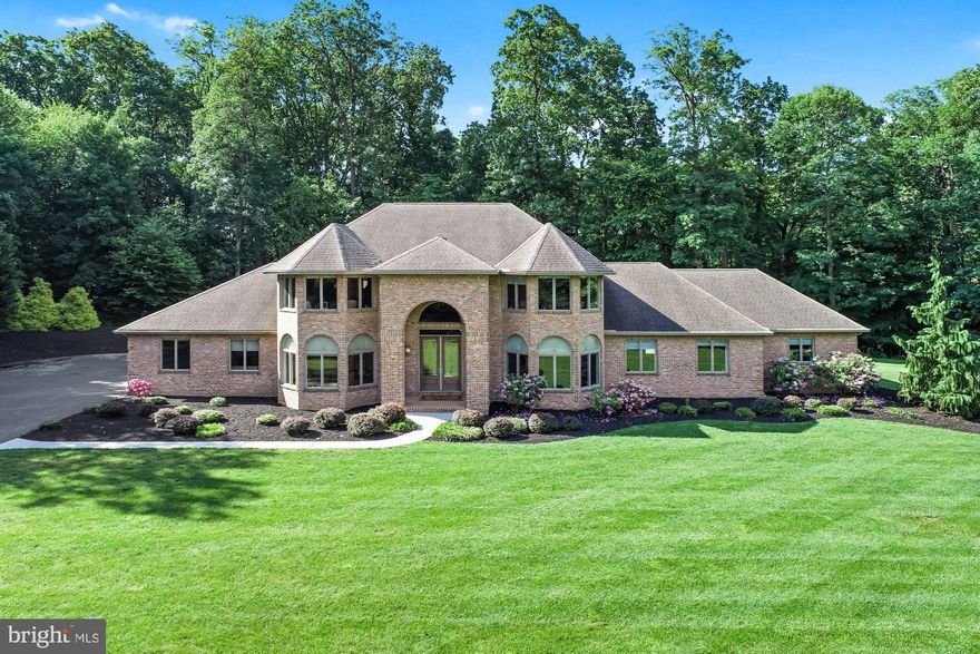 Reflect your success, Entertain in Style, Move Everyone with You…..This massive custom built 6 bedroom, 7 full bath/1 half bath brick contemporary, on a private, partially wooded 2 acre lot, combines architecture and craftsmanship into a home that whispers, “success.”  With its high ceilings, luxury appointments, and gleaming Brazilian  Cherry and Brazilian Teak (non-fading) flooring, this home offers over 7000 sq ft of gracious living space, on two levels, with another 4300+ sq ft of finished living space, in the lower level. PLUS it has another 1000+ sq ft of partially unfinished living space, in the lower level. To say the house is massive, is an understatement!  Other than the powder room and a partially finished lower level utility room, there isn't a small room in the home! You will love the open and flowing floorplan perfect for grand entertaining or intimate gatherings.  Enjoy cooking in the beautiful granite kitchen, while family and friends gather at the bar, sit at the dining table, or lounge in the family room. Imagine the fun you can have in the 24x28 cathedral ceiling family room. Windows and patio door allow you to enjoy the beauty of the lot or take the party onto the large deck. The kitchen showcases stainless steel appliances, island/bar with sink, dual pantry, and enough space to feed an army. Never worry about working remote, with the 1st floor office, closed off by double French Doors. A stunning 1256 sq ft primary suite has enough space for bedroom, office, and living furniture. It features a custom designed 10x16 walk-in closet and 13x17 luxury bath with whirlpool tub, 5x6 walk-in tiled shower, with triple shower heads, toilet closet, double vanities, and heat lamps. The 1st floor laundry room and powder room are located directly off the kitchen and have quick access to both the garage and side patio area. Three additional bedroom suites, each with private granite baths, with heat lamps, walk-in closets, and Brazilian Teak flooring, are located on the 2nd floor. Just when you thought the home cannot get any larger, you go to the lower level where there are 3 HUGE rooms, 2 full bathrooms, and several partially/unfinished rooms. Let your creativity soar…..game room, media room, theater room, indoor bounce house…. oh my, the sky is the limit, with all the space! The area has rough-in for a 2nd kitchen and wet bar.  It also has an outside entrance and steps leading to the garage interior.  In 2010, the owner added 1596 sq ft, self-contained living quarters consisting of a living room, Brazilian Teak flooring, eat-in kitchen, two bedrooms and a full bath, with roll-in tiled shower and  triple shower heads.  It has sound-proof walls, safety intercom system, security cameras, separately zoned heating and air conditioning, a private outside entrance, and a lockable entrance into the main house. The driveway is wired for a gated entrance. Finished 4-car end-load garage with heating, air conditioning, and water line for refrigerator. Home is private, yet minutes to conveniences, Rt30 and I83…. perfect for commuting to Lancaster, Harrisburg, Maryland, or even Philadelphia.  A lot of house for the money! We dare you to try and duplicate it for the list price!  AGENTS – Please read Agent Remarks!