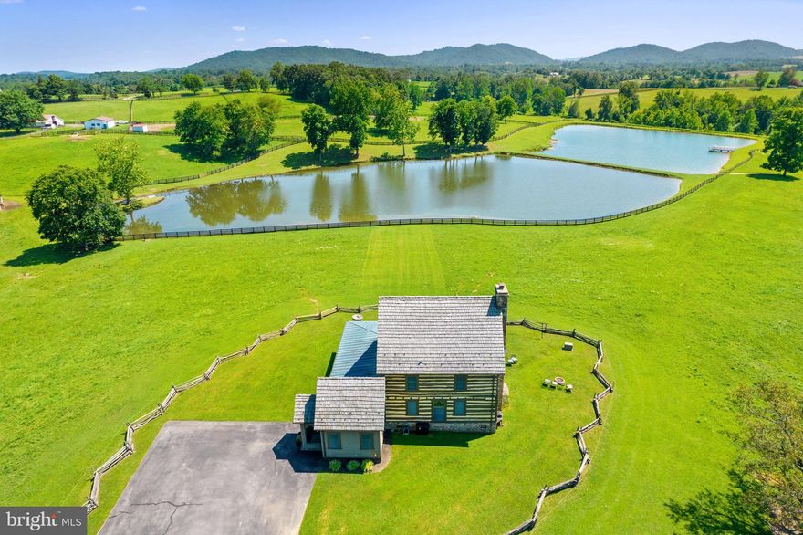 This property is 91 acres of beautiful rolling hills and pastures located north of the village of Flint Hill. This scenic property is surrounded by unspoiled countryside and expansive views of the Blue Ridge Mountains. This property consists of 2 residences: 1 historic log cabin and 1 tenant house, a 10-stall barn, and 8-acre spring fed pond, 7 paddocks and multiple run-in sheds. 
Sited next to the pond is the Lodge, a historic log house first built as a tavern in 1790. It was moved to Windsor Lodge Farm in 1990, restored and preserved with original structure and some additional change. The lodge features a great room with fireplace and full kitchen, with a spacious wrap around addition for dining and entertaining. The upper level features a spacious bedroom and bath. The lodge has most recently been used as an Airbnb rental for weekend getaway trips.
The tenant home located near the barn has 3 bedrooms and 2 bathrooms. The primary bedroom has a bath roomed attached with a shower. The second bathroom has a tub/shower. The house has an open plan kitchen with dining area and separated living room.
The 10-stall barn includes a tack room and feed room, an outdoor wash stall, a riding ring, 5 run-in sheds, and 7 paddocks equipped with automatic waterers. There is also a small storage shed and a bigger machine shed right by the barn. 
You will be surrounded by spectacular views of the 8-acre spring fed pond and the Blue Ridge Mountains anywhere you stand on the property. 
This is Lot #2- The current gated entrance from Jericho Road belong to the adjoining Lot #1- with the address 4 Windsor Lodge Lane. The purchases of Lot #2 will be responsible for installing a new driveway entrance within the first year of purchase. The majority of the entrance road to Lot #2 is on this parcel and will not need to be moved. 
Tax Map #13-145A is a new Rappahannock County number from portions of T.M.#13-145 & 5-14. There are not current assessed values at this time.