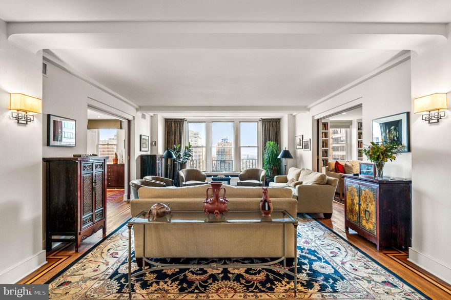 An exceptional offering at The Rittenhouse Plaza with over seventy feet of park frontage and thirteen windows overlooking Rittenhouse Square. This expansive corner three bedroom, three bathroom residence spans more than 2,400 square feet and enjoys three coveted exposures—east, south, and west, filling the interiors with natural light and capturing sweeping views of Rittenhouse Square, Walnut Street, and dramatic sunsets. The foyer opens into a spacious living and dining area with hardwood floors accented by mahogany inlay, creating an inviting setting for both everyday living and entertaining. The thoughtfully designed kitchen is highlighted by quartz countertops, a large center island with seating, vented gas cooking by Zephyr, extensive cabinetry, multiple pantries, and four large windows that bring in natural light and fresh air.  The private primary suite offers a peaceful retreat with a sitting room or office, a customized walk-in closet, and a luxurious en-suite bath featuring a frameless glass shower, double vanities with medicine cabinets, private commode, a built-in linen closet, and a window. The second bedroom is versatile with a Murphy bed, two closets, custom built-ins, and an en-suite bath. The third bedroom, currently used as a den, is appointed with custom bookshelves, built-in cabinetry, recessed lighting, and a ceiling fan. The third full bath is finished with floor-to-ceiling tile, a walk-in shower with bench, and a frameless glass door. Additional features include a separate laundry room with a full-size LG washer and dryer, multiple walk-in closets, and three zones of efficient Bosch water-source heat pumps. The Rittenhouse Plaza is one of Philadelphia’s premier New York style pre-war cooperatives, offering 24 hour concierge service, a beautifully landscaped courtyard, and a pet friendly environment. The monthly co-op fee includes real estate taxes, Fios cable, internet, water, sewer, and building maintenance. A deeded parking space at the Wanamaker House is available for purchase. Perfectly located in the heart of Rittenhouse Square, this home provides a rare combination of space, views, and convenience with world-class dining, shopping, and cultural destinations just outside your door.