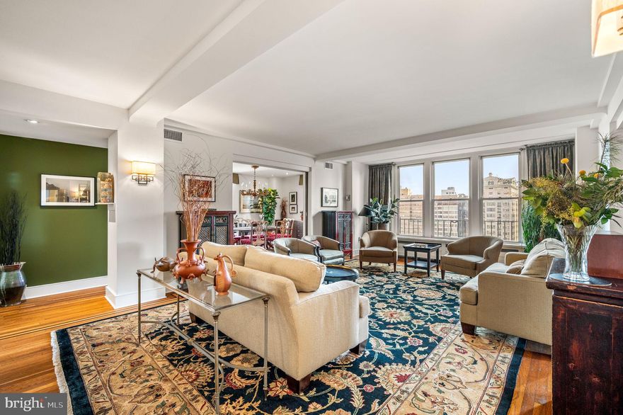 An exceptional offering at The Rittenhouse Plaza with over seventy feet of park frontage and thirteen windows overlooking Rittenhouse Square. This expansive corner three bedroom, three bathroom residence spans more than 2,400 square feet and enjoys three coveted exposures—east, south, and west, filling the interiors with natural light and capturing sweeping views of Rittenhouse Square, Walnut Street, and dramatic sunsets. The foyer opens into a spacious living and dining area with hardwood floors accented by mahogany inlay, creating an inviting setting for both everyday living and entertaining. The thoughtfully designed kitchen is highlighted by quartz countertops, a large center island with seating, vented gas cooking by Zephyr, extensive cabinetry, multiple pantries, and four large windows that bring in natural light and fresh air.  The private primary suite offers a peaceful retreat with a sitting room or office, a customized walk-in closet, and a luxurious en-suite bath featuring a frameless glass shower, double vanities with medicine cabinets, private commode, a built-in linen closet, and a window. The second bedroom is versatile with a Murphy bed, two closets, custom built-ins, and an en-suite bath. The third bedroom, currently used as a den, is appointed with custom bookshelves, built-in cabinetry, recessed lighting, and a ceiling fan. The third full bath is finished with floor-to-ceiling tile, a walk-in shower with bench, and a frameless glass door. Additional features include a separate laundry room with a full-size LG washer and dryer, multiple walk-in closets, and three zones of efficient Bosch water-source heat pumps. The Rittenhouse Plaza is one of Philadelphia’s premier New York style pre-war cooperatives, offering 24 hour concierge service, a beautifully landscaped courtyard, and a pet friendly environment. The monthly co-op fee includes real estate taxes, Fios cable, internet, water, sewer, and building maintenance. A deeded parking space at the Wanamaker House is available for purchase. Perfectly located in the heart of Rittenhouse Square, this home provides a rare combination of space, views, and convenience with world-class dining, shopping, and cultural destinations just outside your door.