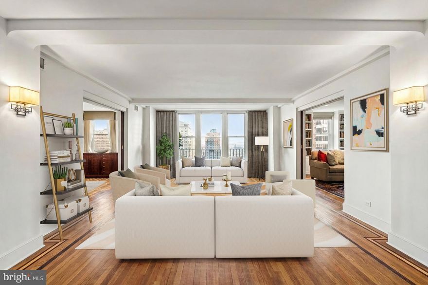An exceptional offering at The Rittenhouse Plaza with over seventy feet of park frontage and thirteen windows overlooking Rittenhouse Square. This expansive corner three bedroom, three bathroom residence spans more than 2,400 square feet and enjoys three coveted exposures—east, south, and west, filling the interiors with natural light and capturing sweeping views of Rittenhouse Square, Walnut Street, and dramatic sunsets. The foyer opens into a spacious living and dining area with hardwood floors accented by mahogany inlay, creating an inviting setting for both everyday living and entertaining. The thoughtfully designed kitchen is highlighted by quartz countertops, a large center island with seating, vented gas cooking by Zephyr, extensive cabinetry, multiple pantries, and four large windows that bring in natural light and fresh air.  The private primary suite offers a peaceful retreat with a sitting room or office, a customized walk-in closet, and a luxurious en-suite bath featuring a frameless glass shower, double vanities with medicine cabinets, private commode, a built-in linen closet, and a window. The second bedroom is versatile with a Murphy bed, two closets, custom built-ins, and an en-suite bath. The third bedroom, currently used as a den, is appointed with custom bookshelves, built-in cabinetry, recessed lighting, and a ceiling fan. The third full bath is finished with floor-to-ceiling tile, a walk-in shower with bench, and a frameless glass door. Additional features include a separate laundry room with a full-size LG washer and dryer, multiple walk-in closets, and three zones of efficient Bosch water-source heat pumps. The Rittenhouse Plaza is one of Philadelphia’s premier New York style pre-war cooperatives, offering 24 hour concierge service, a beautifully landscaped courtyard, and a pet friendly environment. The monthly co-op fee includes real estate taxes, Fios cable, internet, water, sewer, and building maintenance. A deeded parking space at the Wanamaker House is available for purchase. Perfectly located in the heart of Rittenhouse Square, this home provides a rare combination of space, views, and convenience with world-class dining, shopping, and cultural destinations just outside your door.