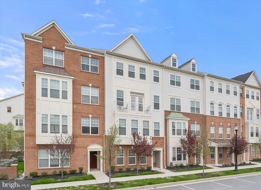 Welcome to this exquisite garage townhome in the sought-after Oxford Square community, where modern convenience meets refined comfort in an amenity-rich setting. Thoughtfully designed across multiple levels, this home features the rare luxury of a private elevator connecting the entry level to the upper floor, enhancing both accessibility and everyday ease. Bright interiors are complemented by abundant windows and recessed lighting, creating a warm and inviting atmosphere throughout.
At the heart of the home, the upgraded kitchen impresses with granite countertops, stainless steel appliances including a wall oven and range hood, and an expansive island with breakfast bar seating, perfectly positioned between the living and dining spaces for seamless entertaining. The dining room is generously sized and elevated by a butler’s pantry and direct access to the deck, ideal for indoor-outdoor gatherings. Just beyond, the spacious living room opens to a balcony through an atrium door topped with a transom window, while a versatile alcove offers the perfect nook for a home office or play area. 
Upstairs, the primary suite serves as a private retreat, highlighted by a tray ceiling and a walk-in closet with an upgraded organization system. The en-suite bath features a double sink vanity with granite counters, a soaking tub, and a separate tiled shower. Two additional bedrooms share a well-appointed hall bath, also complete with a double sink vanity, providing both comfort and functionality.
A rear-loading one-car garage and front balcony overlooking the charming community barn add to the home’s appeal. Residents of Oxford Square enjoy exceptional amenities, including a pool, fitness center, clubhouse, walking paths, and a unique barn venue available for private events. Ideally located near BWI Airport, Fort Meade, MARC Train Station, and major commuter routes such as MD-100, MD-295, and I-95, this home also benefits from proximity to shopping, dining, entertainment, and highly regarded Howard County schools. Here, lifestyle and location come together effortlessly.