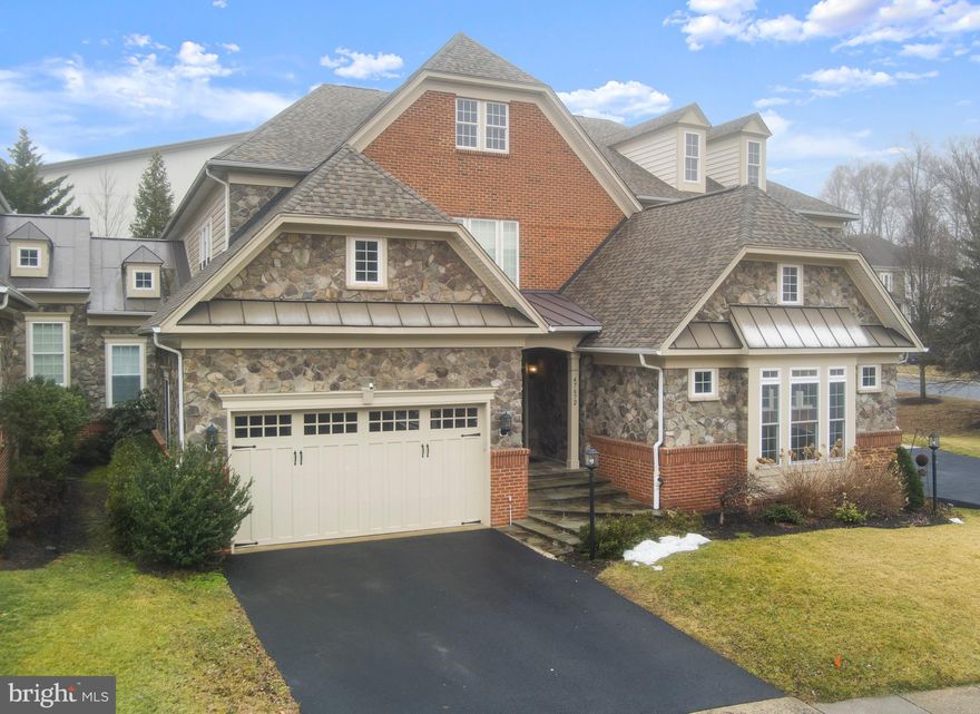 This rarely available and elegant carriage home welcomes you with a dramatic 2 story entry foyer complemented by 9-foot ceilings on every level.  The foyer opens to formal living and dining rooms that are adjacent to the gourmet kitchen and family room. The kitchen features granite countertops and luxury appliances, and opens to a private deck for gracious outdoor dining. The main level includes the luxurious primary suite with an ensuite bathroom, generous walk-in closet and private deck.  A powder room and discrete laundry room complete the amenities on the main level.

The Upper Level features three large bedrooms with spacious closets and two bathrooms, one which is ensuite with a bedroom.  A family-oriented open space overlooks the foyer and includes a study/work from home desk area with built in bookcases. 

The fully finished Lower Level includes a large media room, fifth bedroom / home office / exercise room, a wet bar, and a full bathroom. The recently updated home systems are located on this level.

All of the many closets in this home are fitted with Elfa© storage systems.

This carriage home has the appearance and curb appeal of single family home with a 2 car garage with all simplified maintenance of an attached home!

Well-sited in the amenity-rich Lowes Island community where many shopping and dining options create a great quality of life.