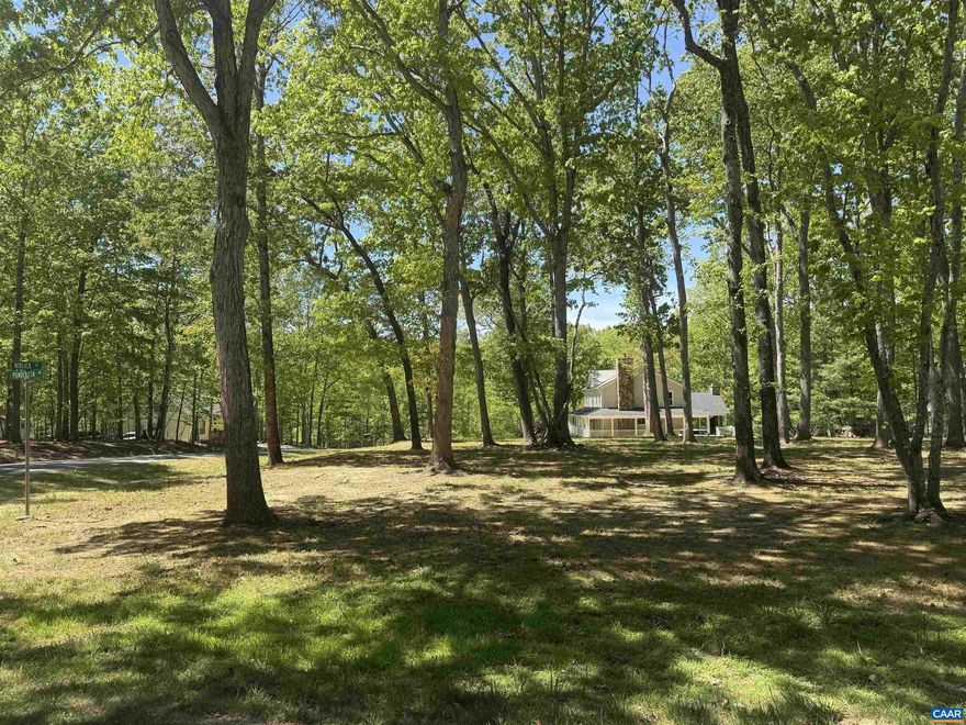S0 MUCH TO OFFER! One of the most picturesque level corner lots at Lake Monticello.  A well-kept vacant lot in excellent condition, offering a peaceful, park-like setting - an ideal opportunity for building or investment. Easy Walk, only 3 blocks from the Club House, PGA tournament Golf Course. "Only a few trees would need to be removed-most of the clearing has already been completed." Perfect for a one level home.