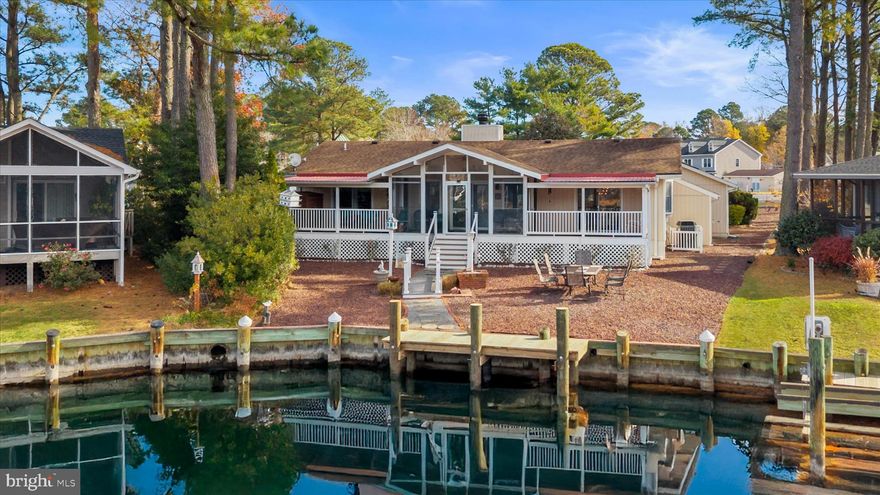 Welcome to this beautiful waterfront home situated on a corner lot with wrap around driveway for easy access to the parkway.  The property features an oversized 2 car garage, newly constructed dock, 2 decks, and a 3 season room overlooking the water. Inside this well maintained home, you'll find new LVP flooring throughout, 3 bedrooms, 2 bathrooms, and a large separate dining room. There's plenty of space for outside entertaining and lots of parking for your guests. The canal has easy access to the Saint Martin's River, which leads you directly to the Isle of Wight Bay. If you're looking for relaxing waterfront living with a community full of amenities, 420 Ocean Parkway has it!