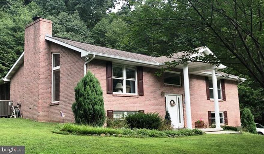 Nestled among the trees, surrounded by tranquility and situated on a 1.243 acre lot, this custom built, one-owner home, is ready for you to move in!  The home is located at the top of the Sherwood Acres subdivision and just minutes from Cumberland, shopping, schools and ATK.  The open floor plan combining the kitchen, dining and living areas features a cathedral ceiling, pine hardwood floors and a beautiful floor-to-ceiling stone, wood-burning fireplace.  The kitchen has plenty of pine cabinets and counter-space.  There are two bedrooms with the master bedroom featuring a large, walk-in closet.  The laundry room is located on the main level so you don't need to carry laundry up and down the steps!  The basement has a large, unfinished room that could be completed to make a nice family room or a third bedroom.  There is a side-entry, 2 car garage and the driveway provides space for additional parking.  Picture yourself sitting on the peaceful patio enjoying that first cup of coffee in the morning or just for that much needed respite at the end of the day.  This home is a must see!  Call Debbie Hidey at 301-268-3619 today for a showing!