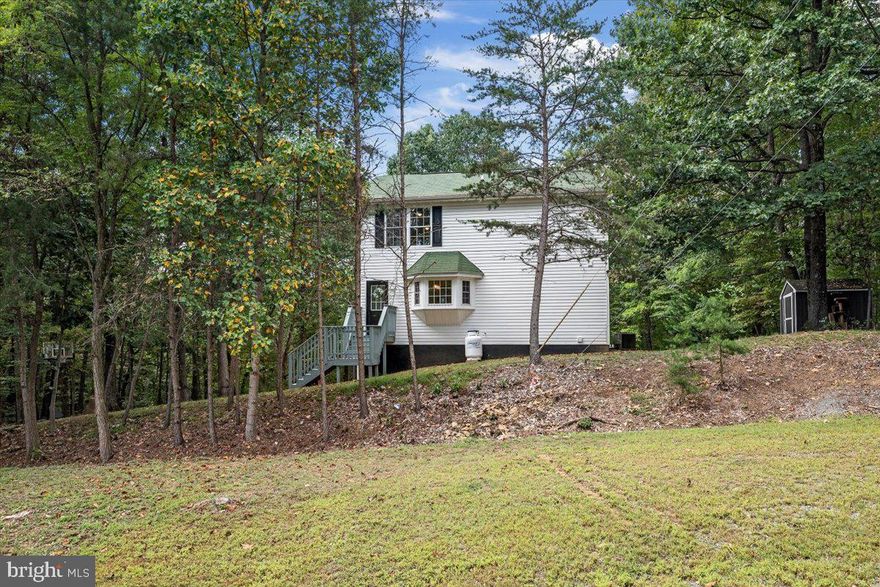 Here's your Year Round Retreat!  Nestled on 5+ Wooded Acres is this delightful 2 Story Home with its own Salt Water pool and Vast Party Deck!  Bask in the sounds of the leaves in trees while sipping your morning coffee or evening beverage gazing over the lights of the 27' above-ground pool.  What a beautiful sight!   Move inside to find Up to Date Decor with New Modern Lighting, Fixtures and paint schemes.  Kitchen is fitted out with Black Stainless Appliances, to include Gas Stove, gorgeous wood floors & beautiful garden window.  Main level Primary Bedroom, just off kitchen, is accentuated with Private primary bath with Tile Shower and Soaker Tub.   Primary Suite is highlighted with access to porch/deck areas perfect to slip out for a morning swim.  Upper level is full of surprises with Spacious Rec Room, Laundry and 2 additional Bedrooms and shared full bath.   Basement level has 1/2 Bath, interior access to one car garage and oodles of storage.  2 Sheds on property offer additional storage space.   This home has so much to offer.  It truly is a YEAR ROUND RETREAT-  Surrounded by the sounds and beauty of nature,  plenty of land to explore and private pool.  Country living doesn't get much better than this.  

Property has been updated -New Light Fixtures and Ceiling Fans, New Heat Pump in 2020,  New Gravel in Drive 2023, 2022 New Maytag Washer & Dryer,  Added New Shed 2021, 27' Salt Water Above Ground Pool 2019 (The Pool Factory). Pressure tank is 2 years old.  Seller says roof is  2004, Water Heater 2011, Pool 4.5 deep,  Ultraviolet Water System is serviced 1 time per year.  Internet is Frontier DSL with Frontier Fiber already in neighborhood development.   Island conveys with stools.  Propane is just for stove; 100 gal leased - Roach Energy. ******professional photos coming 2nd week of September*******