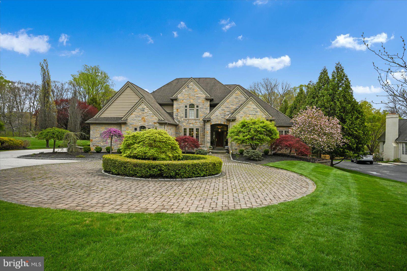 This magnificent home was the former residence of a prominent builder in Delaware and Chester counties. The property includes extensive mill work, fabulous architectural features and a first floor master suite. The circular staircase is an inviting feature as you enter the home and look straight through the living room to the outside grounds that are surrounded by Springton Reservior. The kitchen consists of custom cherry cabinets with granite tops. The family room with a stone fireplace, is situated directly off of the kitchen, and adjacent to the separate bar room area, which makes this home ideal for entertaining. The living room has gas fireplace and is spacious enough to accommodate a baby grand piano and several pieces of furniture. The spacious dining room, open flow has the ability to serve many people for dining on those special occasions. You enter the study through two gorgeous french doors with and arch transom above that mirrors the front entry with the same detail. The Study has a vaulted ceiling and is large enough for desks and book shelves. The upstairs has 3 bedrooms, one of which has a private bath and the second and third bedrooms share a Jack n Jill bathroom The lower level is finished and has possibilities of for many uses. Currently there is a gym area, music room, pool table area, kitchenette, an additional bedroom, full bath, and a tv viewing area with a walk out basement. This lower level could be and outstanding suite for adult children, in laws, out of town guests and many more great possibilities. The exterior of the home has a stone front and the remainder of the three sides are done in siding. A large deck overlooks the backyard with views of the reservoir. The deck steps lead down to paver stone patio area with large pergola area. This is an amazing house that has numerous amenities, Brazilian cherry hardwood floors, a whole house generator, a chandelier lift and more. Schedule your appointment today.