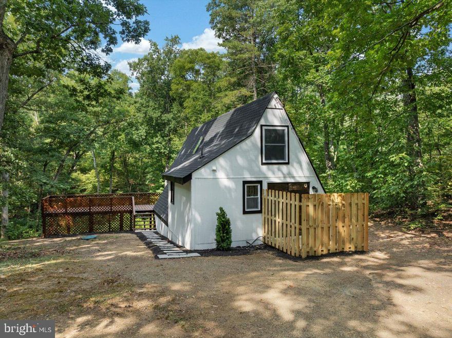 "Escape To Tall Pine Ln" This 1 bed, 1 bath A-Frame Style home sits on .92 acres and has been beautifully renovated! Kitchen has new stainless-steel appliances, new cabinets, new sink, new countertops and a new sink faucet. Bathroom has been renovated with a new tub, new tile surround, new trim kit, new toilet and new faucet. Spacious family room with a wood burning fireplace. Spiral steps up to the loft area. Entire interior repainted, new flooring, new skylight and a new 2-unit mini split system. Enjoy your morning coffee on the large deck that's been freshly stained! Walk down the backyard to the stream or enjoy the neighborhood access to the creek just a short drive down the road.   New 30-year shingle roof, exterior has been painted and fresh landscaping. Come make this home your primary residence, weekend retreat or Airbnb. Septic was pumped in May of 2024. Agent related to owner.