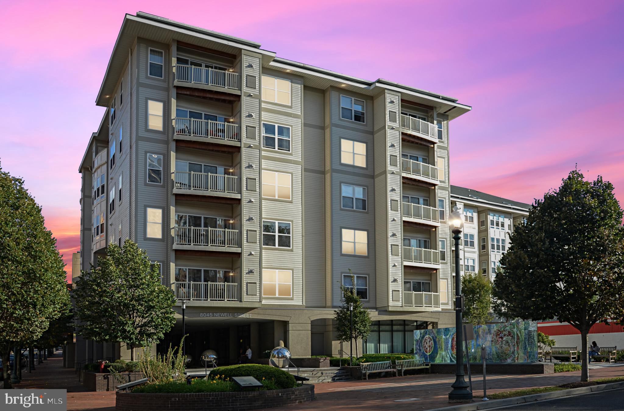 Enjoy the fun and convenience of downtown living in this luxurious two-bedroom, two-bath corner condominium unit. This unit has been totally renovated with new flooring, new light fixtures and ceiling fans, and a fresh coat of paint. The gourmet kitchen, which features granite countertops and stainless steel appliances, overlooks the spacious living room, creating an ideal space for both everyday living and entertaining. An extra-large private patio is accessible from the living room. Ride the metro from Silver Spring Station which is just a few blocks away, or drive and park in your reserved garage parking space.
8045 Newell St is a smoke-free, pet-friendly building offering great amenities like a fitness center, resident lounge, and shared patio. With a walk score of 94, daily errands are a breeze without the need for a car. Nearby, you'll find grocery stores, a new Target, the Shops at Ellsworth Place, and the Silver Spring Transit Center (Metro & MARC). Plus, the soon-to-be-completed Purple Line will make this location even more desirable.